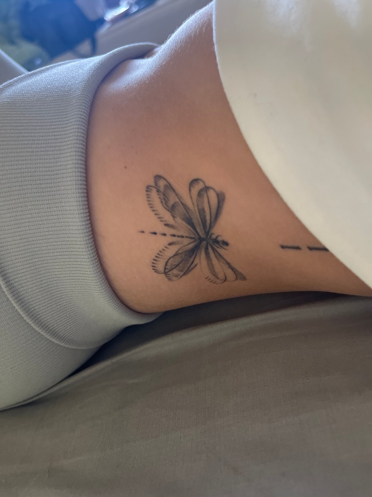 Woman documents afternoon selfie session showing athletic wear and tattoos
