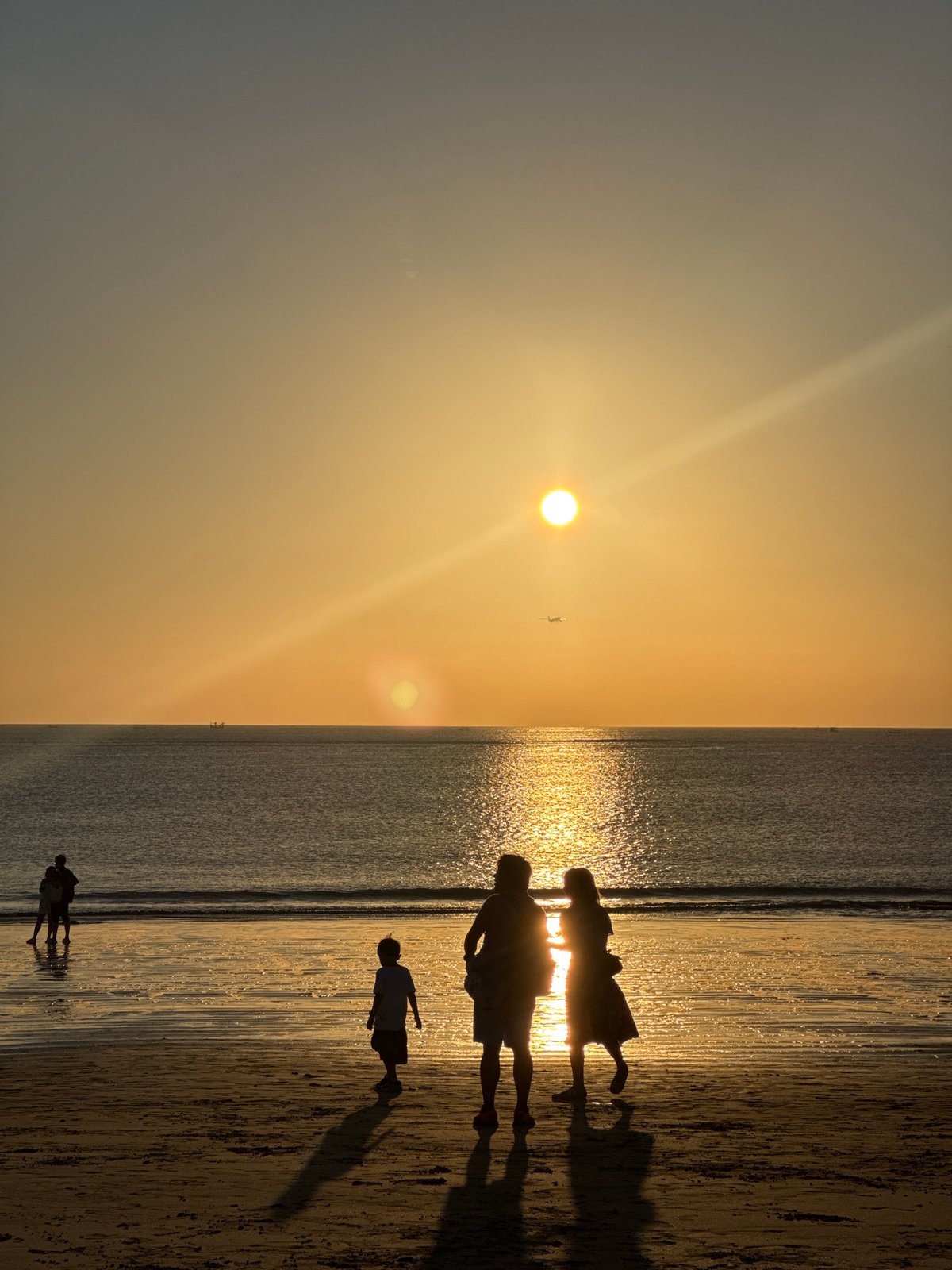 Kuta Selatan beach at golden hour, crowds and kites included