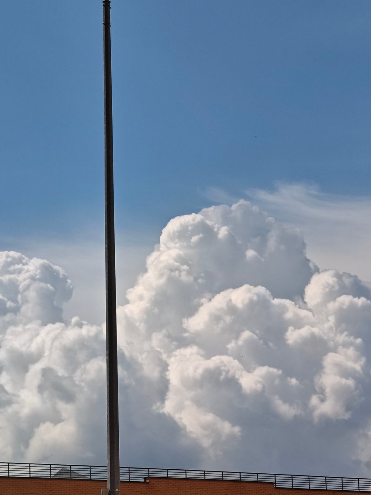 Summer sky and rooftops in Shcherbinka, seen from below