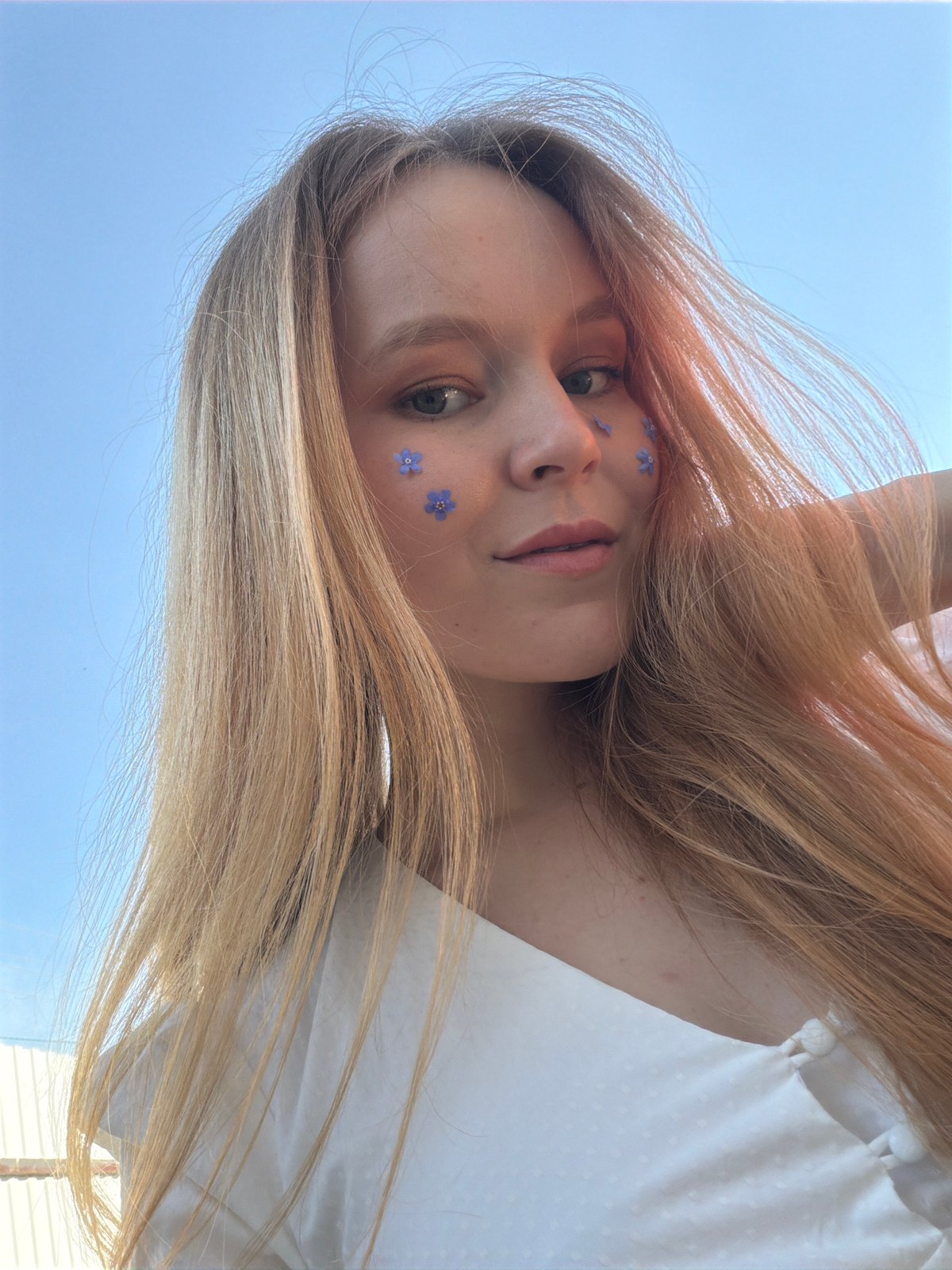Woman poses with blue flowers in Russian field photoshoot