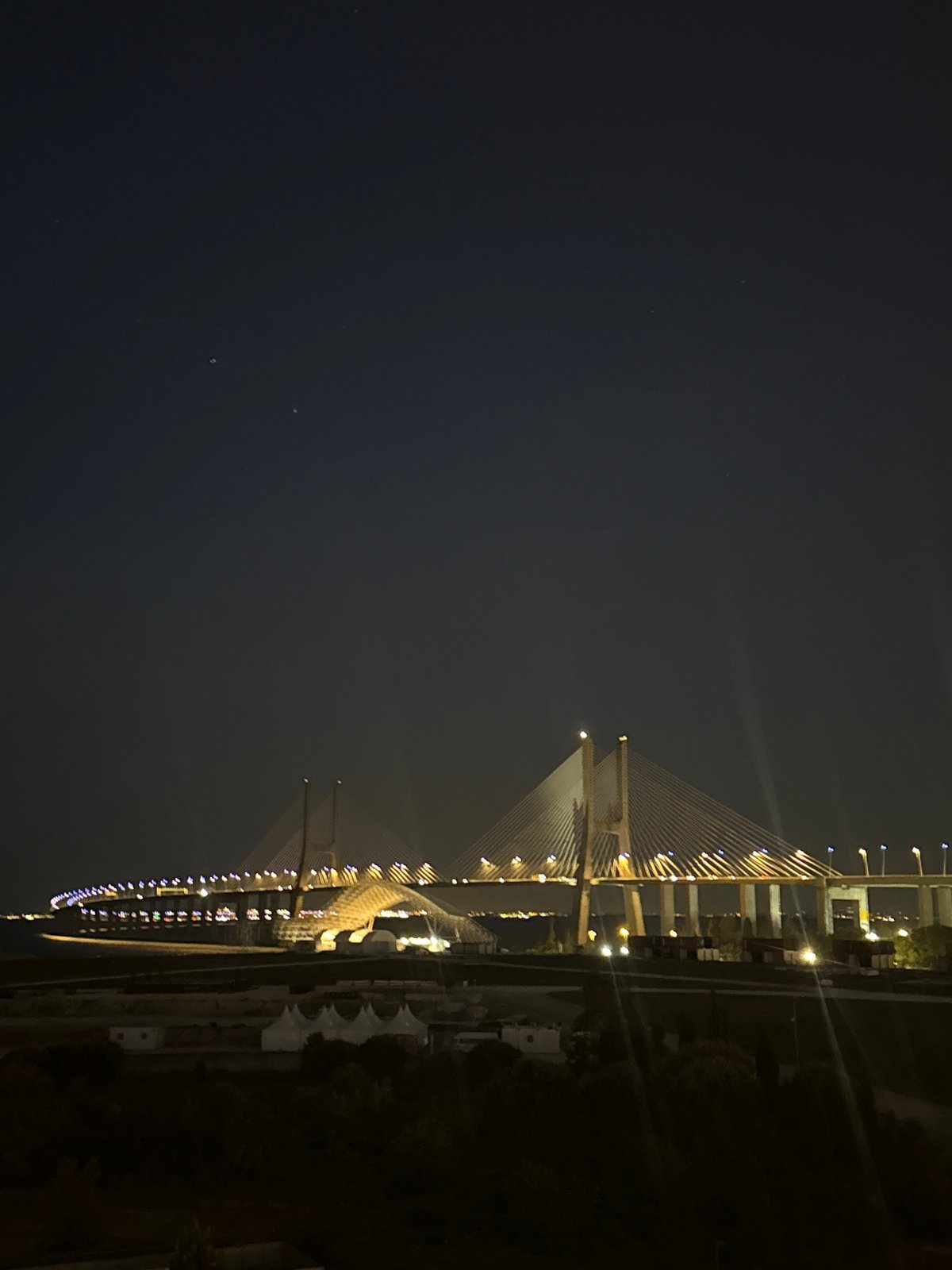 Nighttime view of illuminated Vasco da Gama Bridge captured