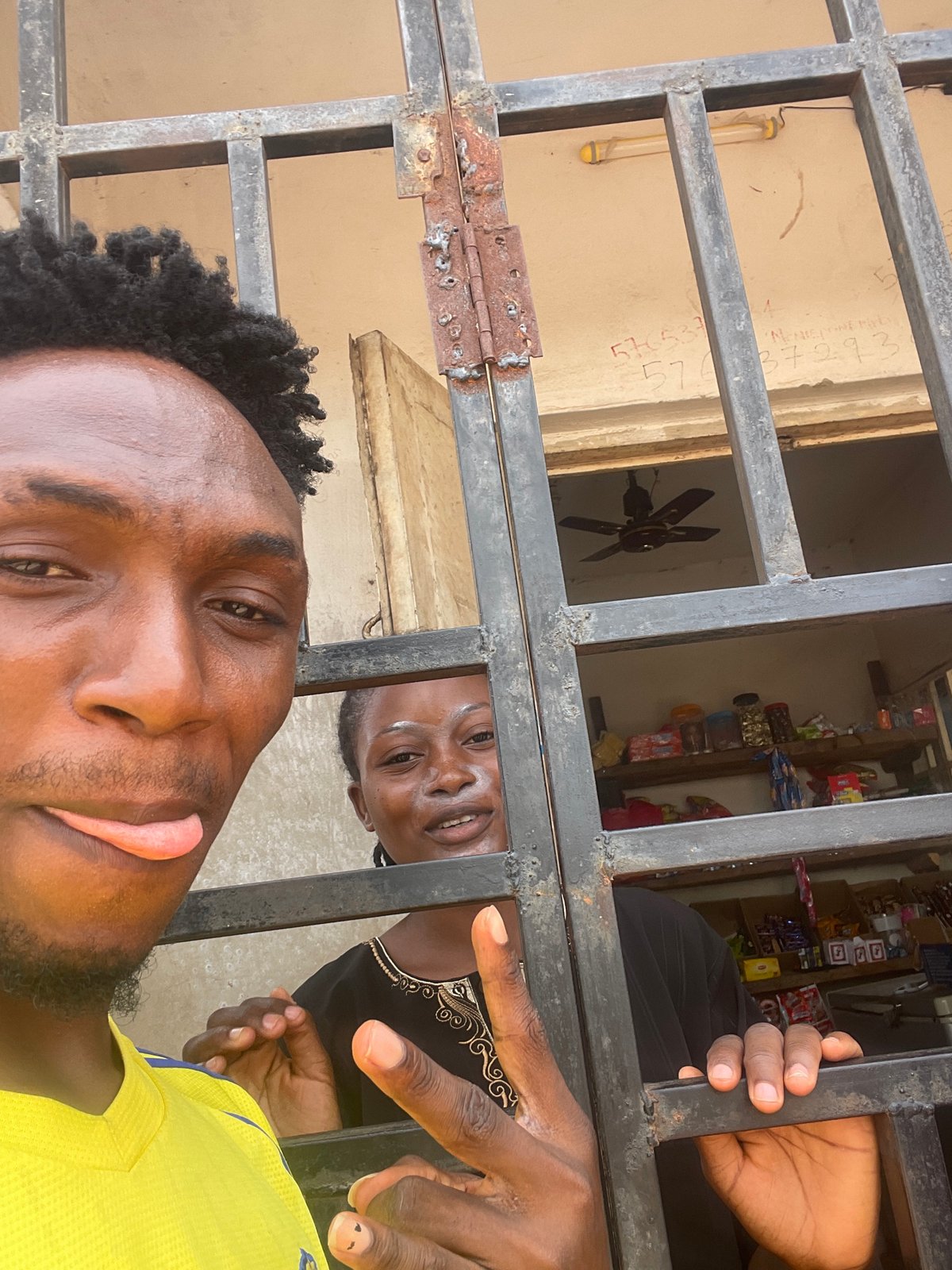 Shop interactions captured through security bars in Lokoja