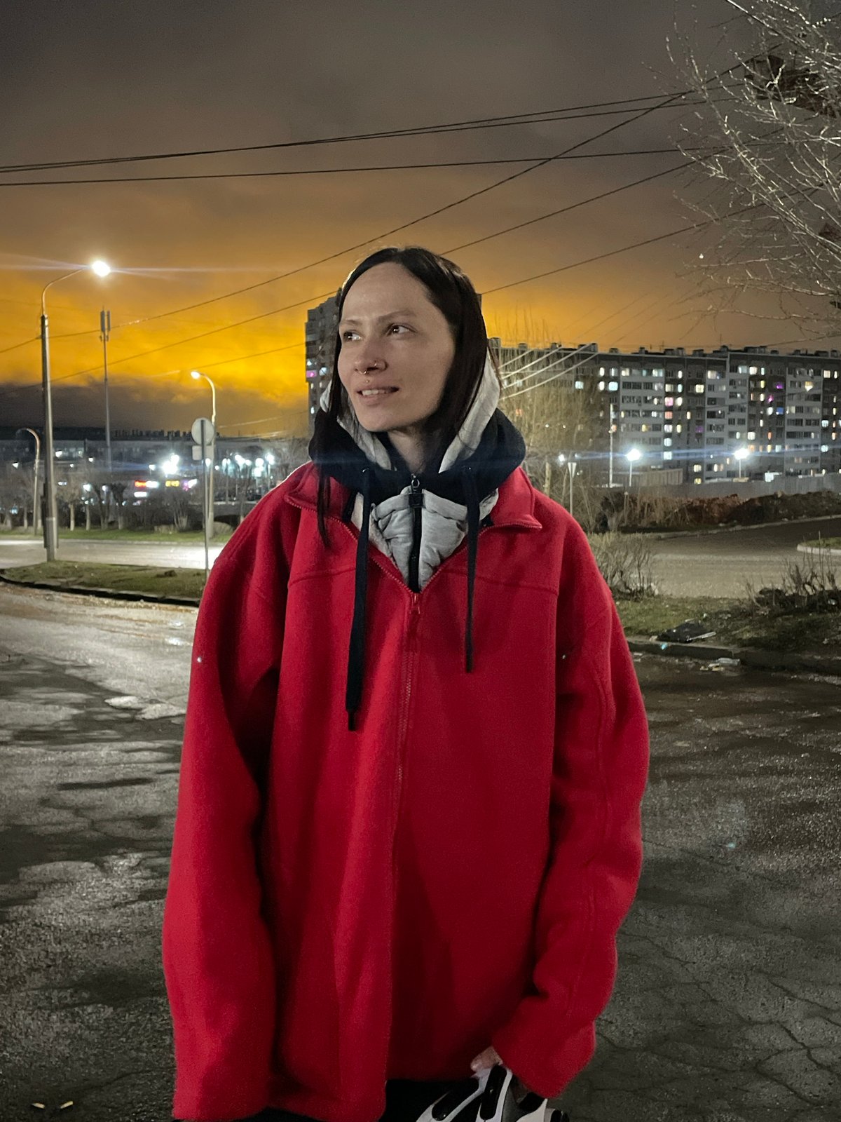 Woman stands outdoors at night in Izhevsk, Russia