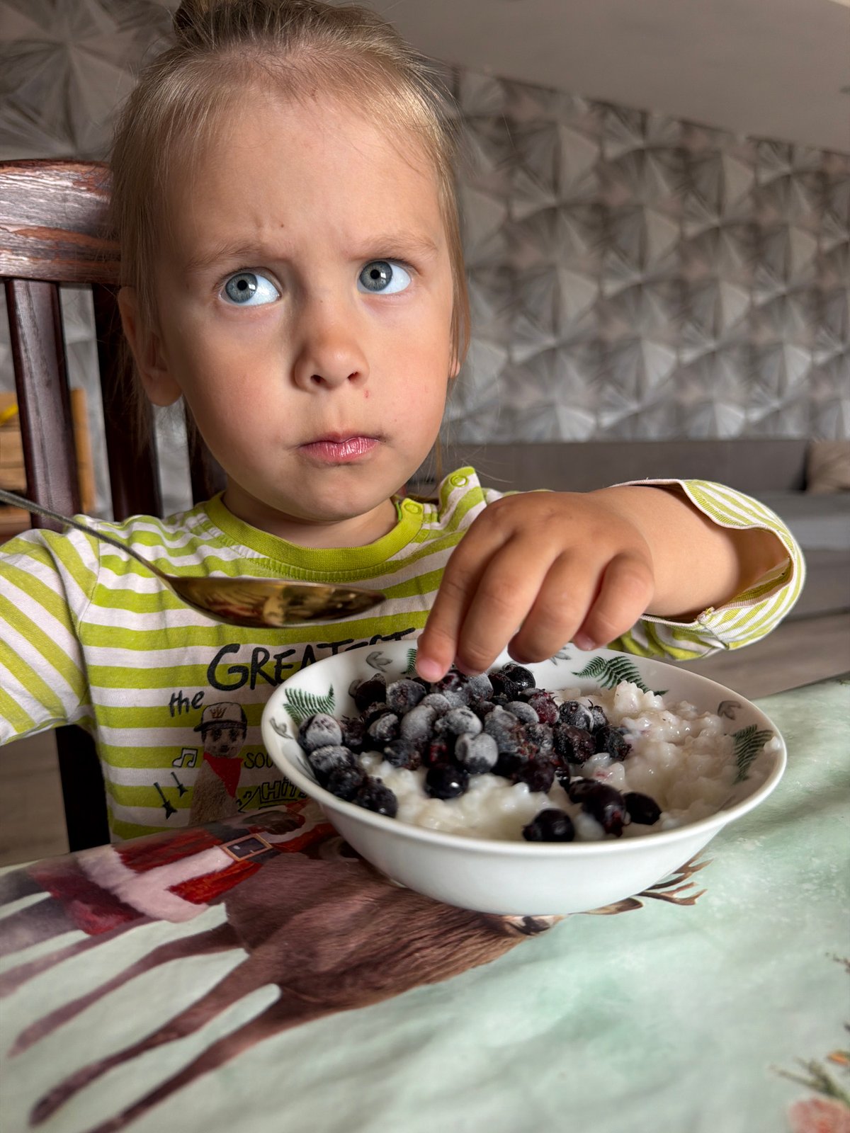Child's breakfast documented in Chaikovsky, Russia morning scene
