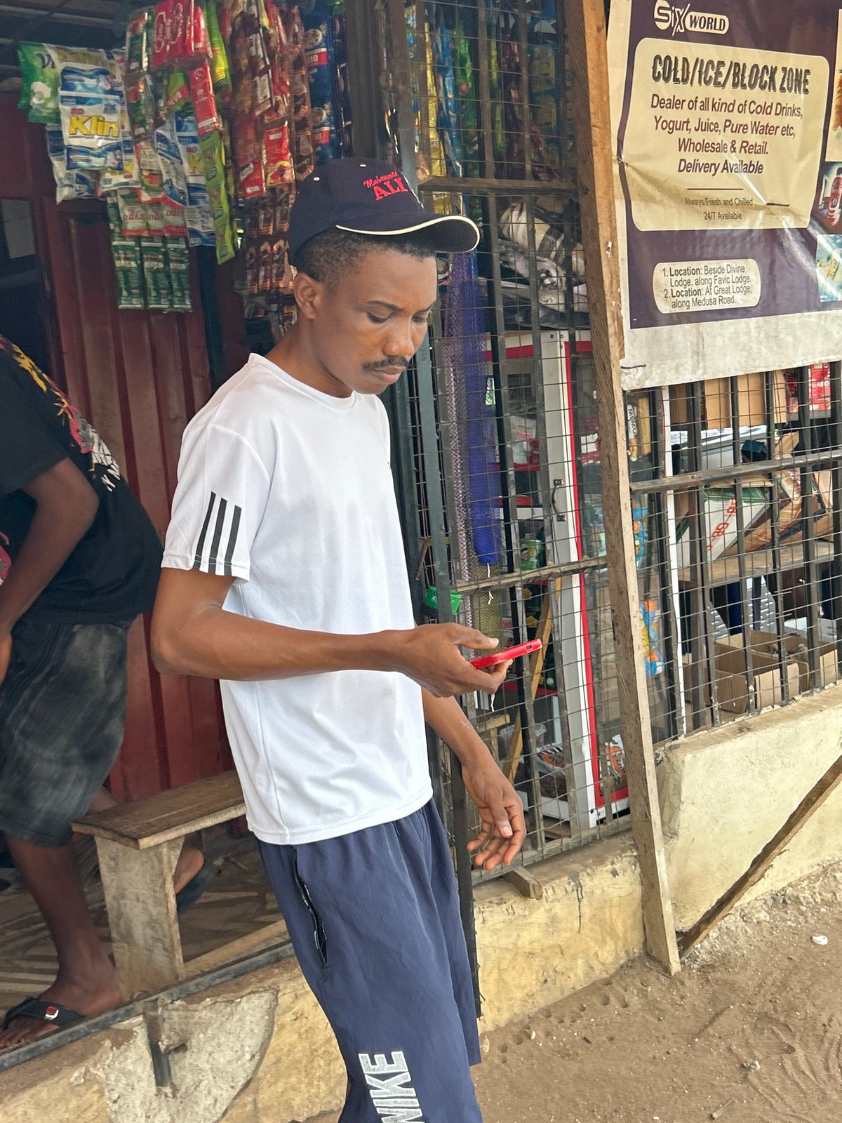 Morning street life along a dirt road in Ihiagwa, Nigeria