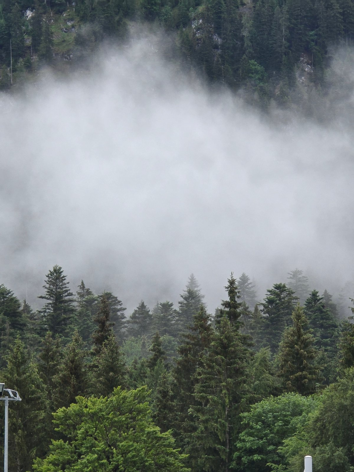 Misty dawn documented at Zugspitze cable car station, Grainau