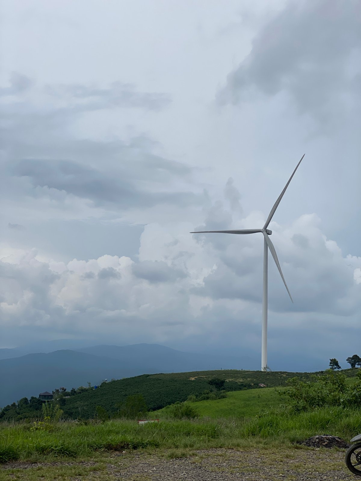 Wind turbines across the misty hills of Trường Thọ, Vietnam