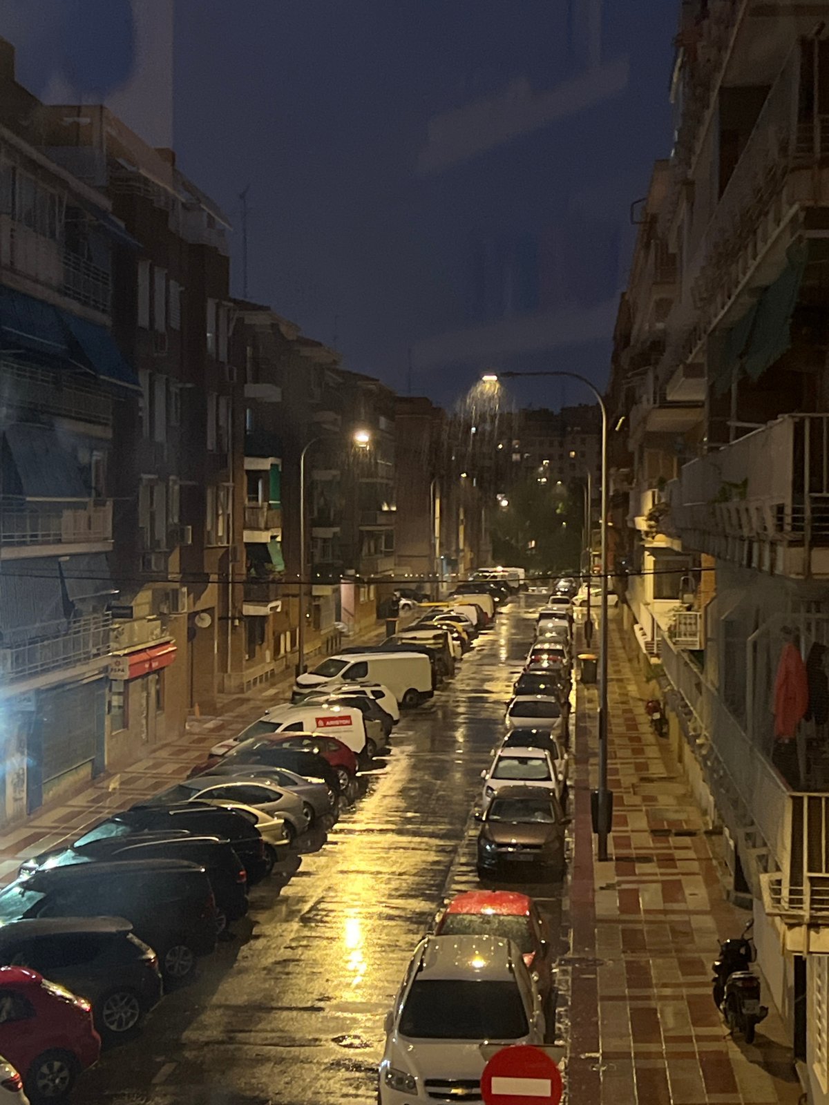 Rainy Madrid evening mixing street scenes with home interiors