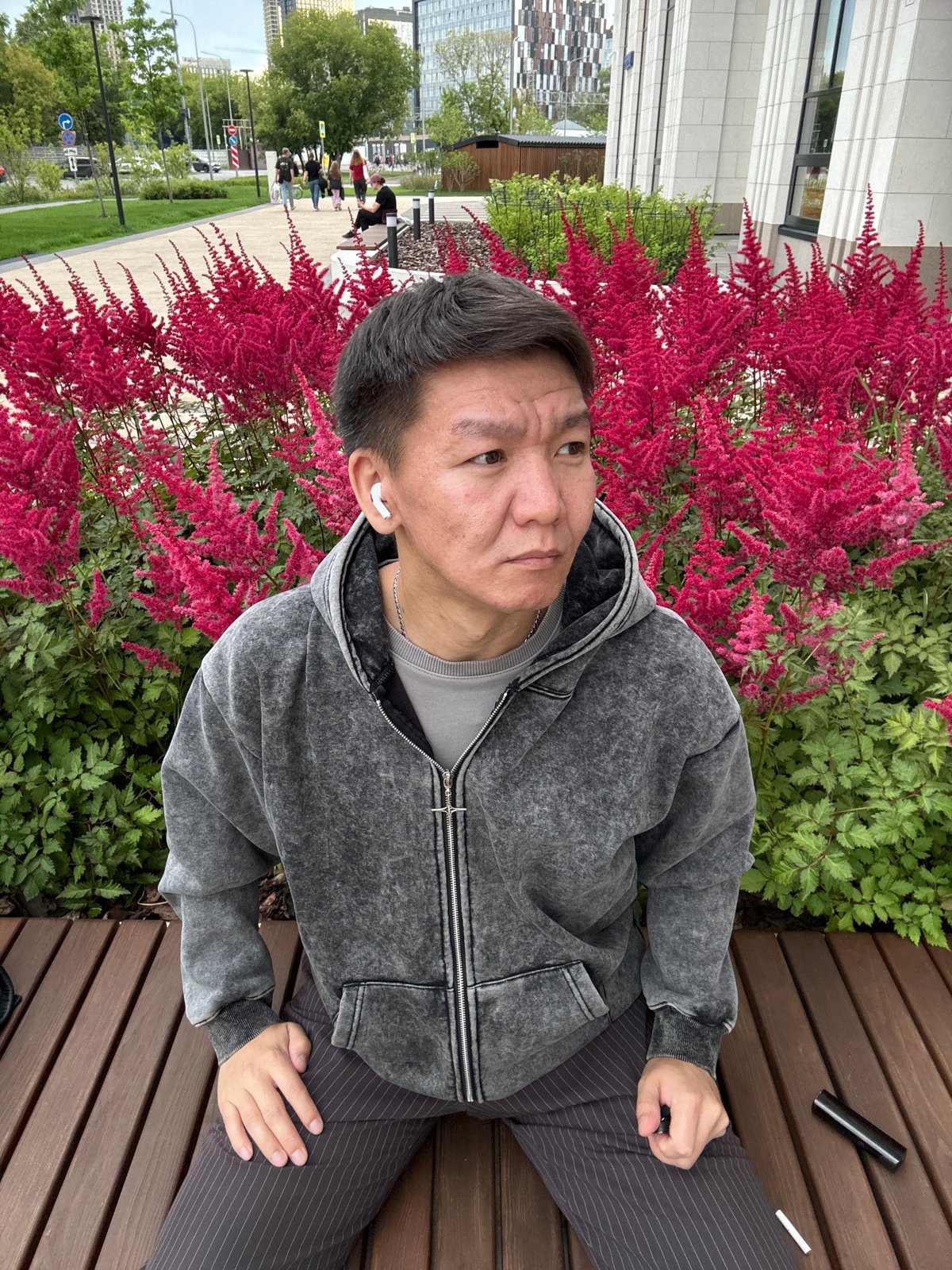 Afternoon in a Khimki park, bench and blooming astilbe flowers.
