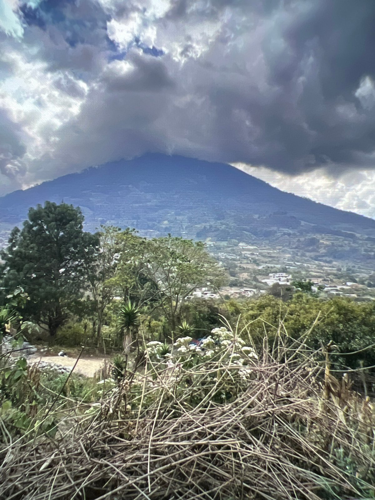 Stormy mountain peak and colorful cobblestone street, same moment