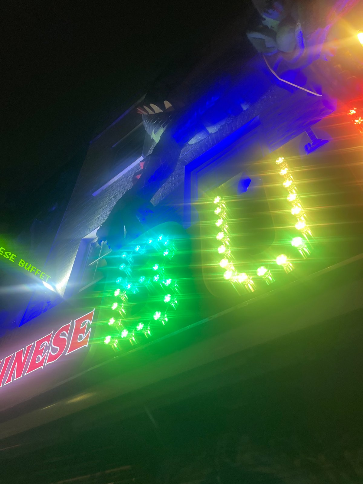 London witness captures illuminated Chinese buffet sign, hand gesture