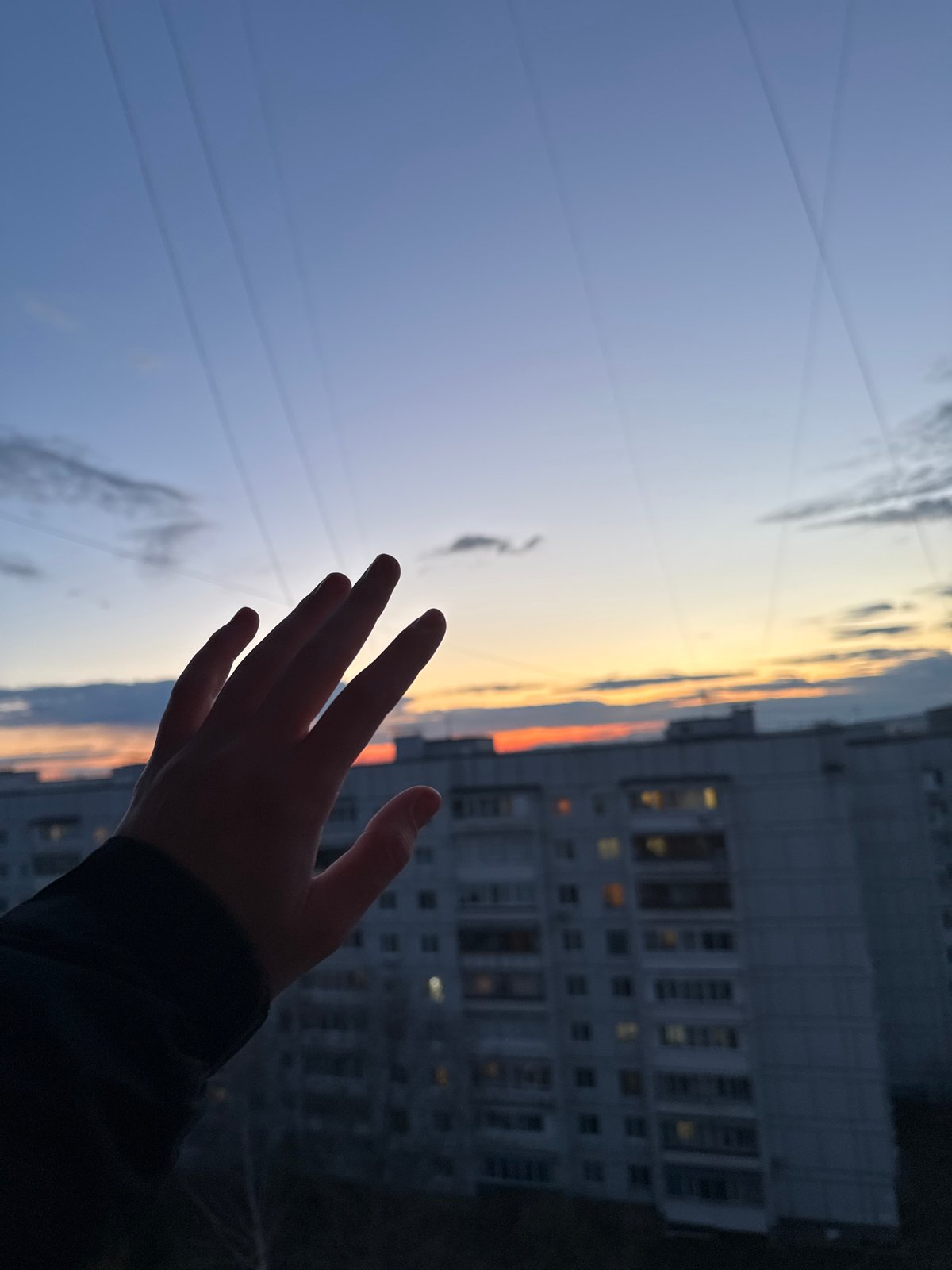 Woman swings at twilight in Chaikovsky, Russia park