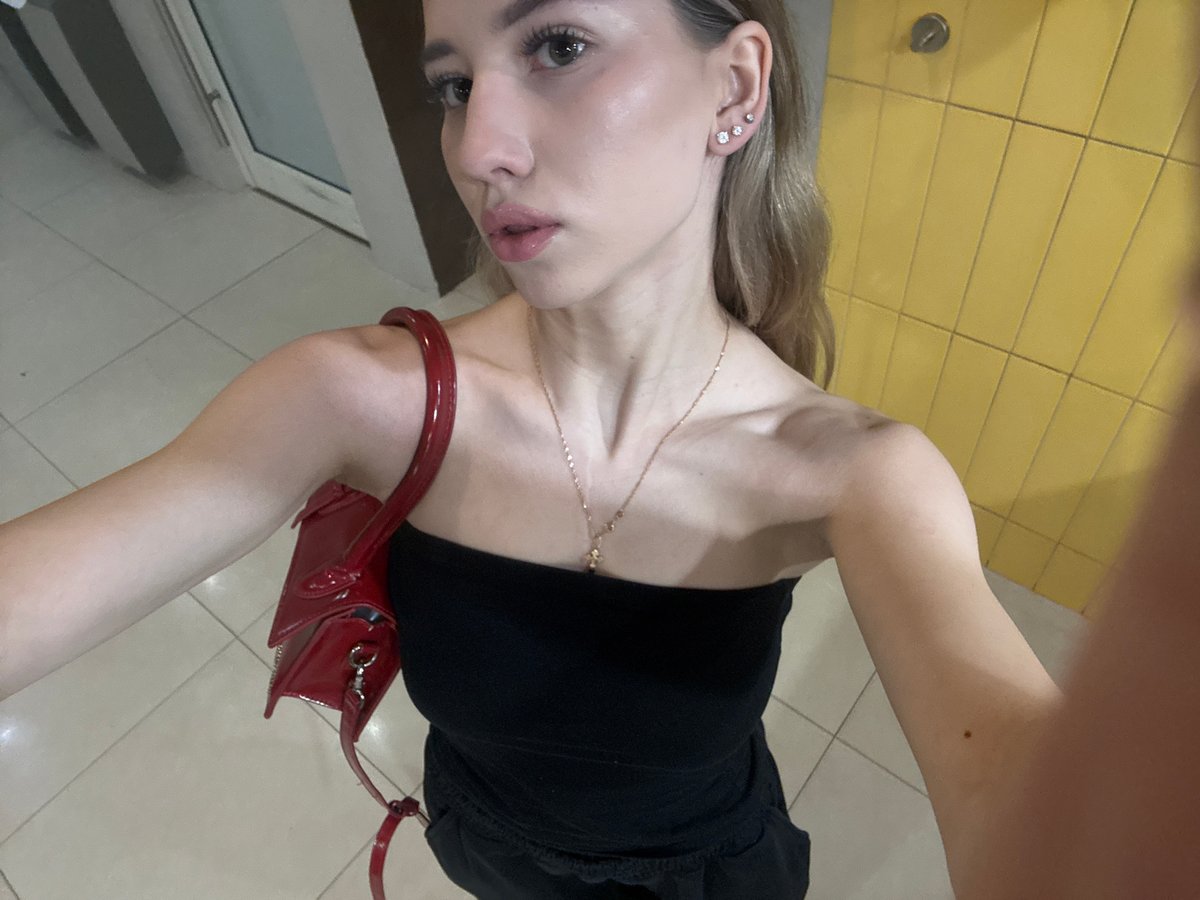 Woman takes selfies in Moscow mirror wearing black top