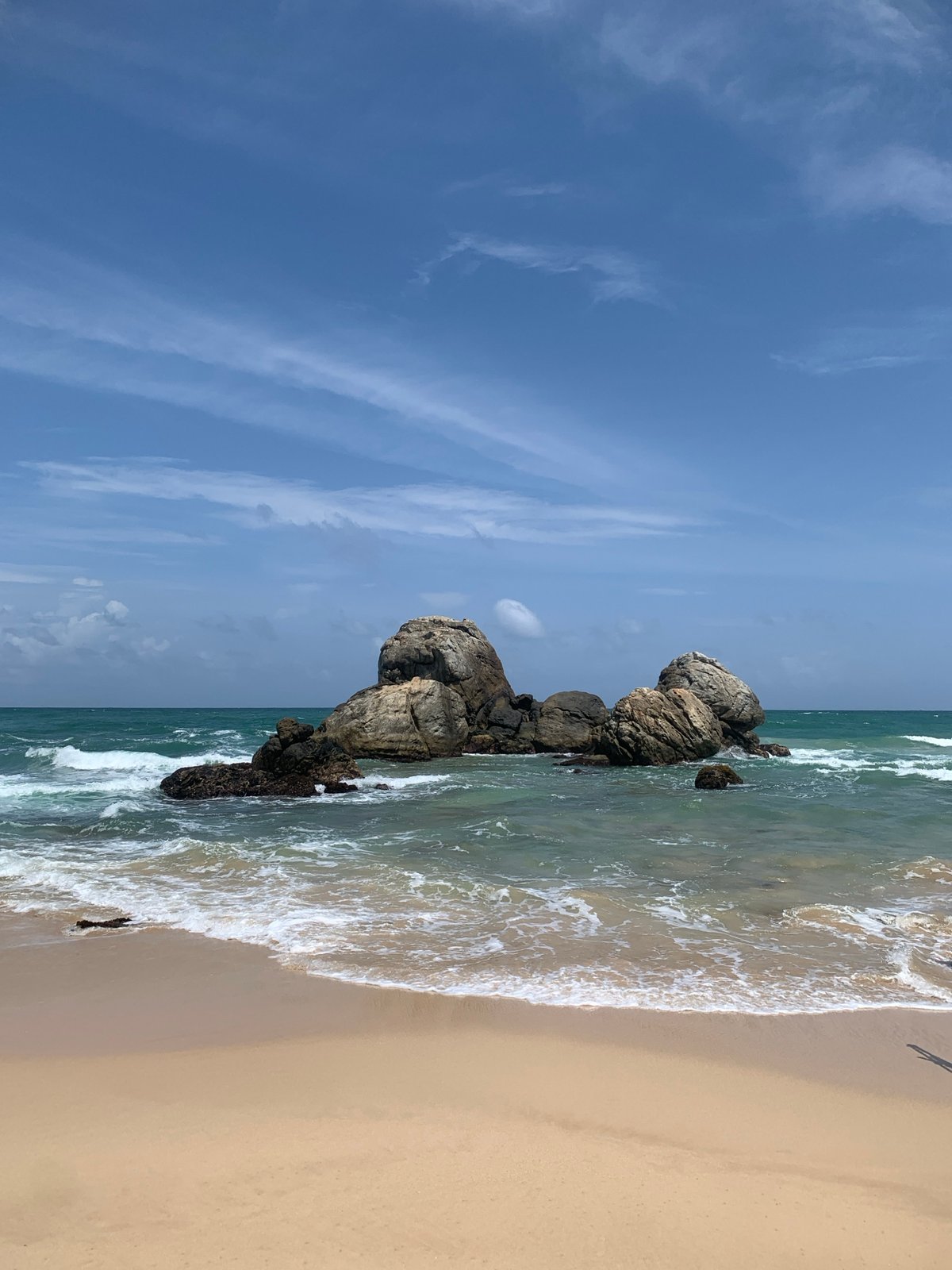 Habaraduwa beach: rocks, fishing boats, and palms at dawn