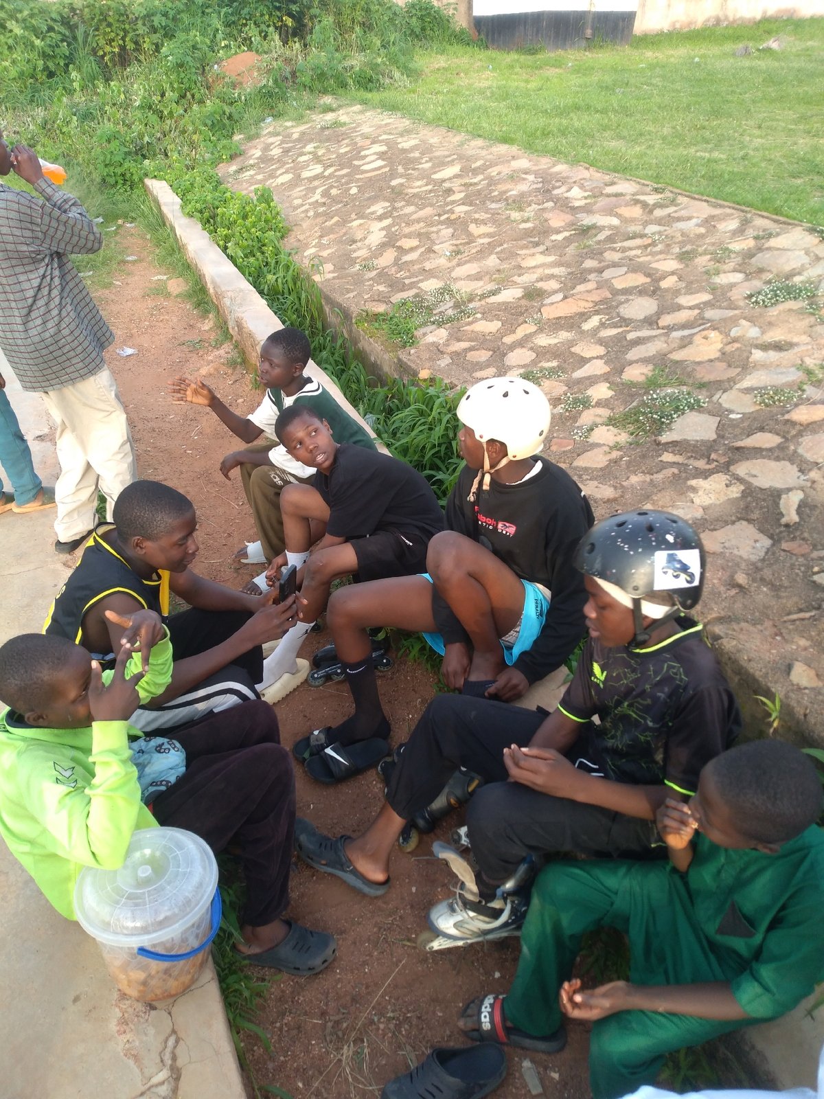 Kids hanging out on a basketball court in Gura Top, Nigeria