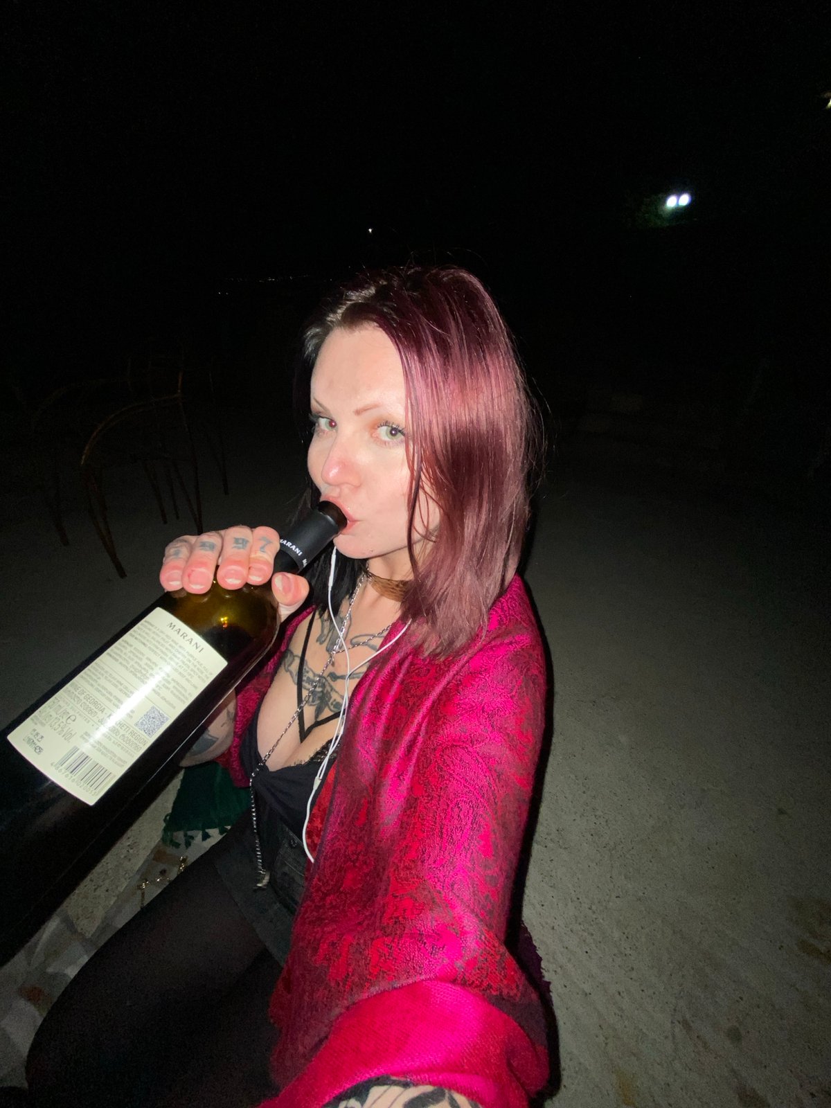 Woman drinks wine, smokes outdoors in Kunje, Montenegro