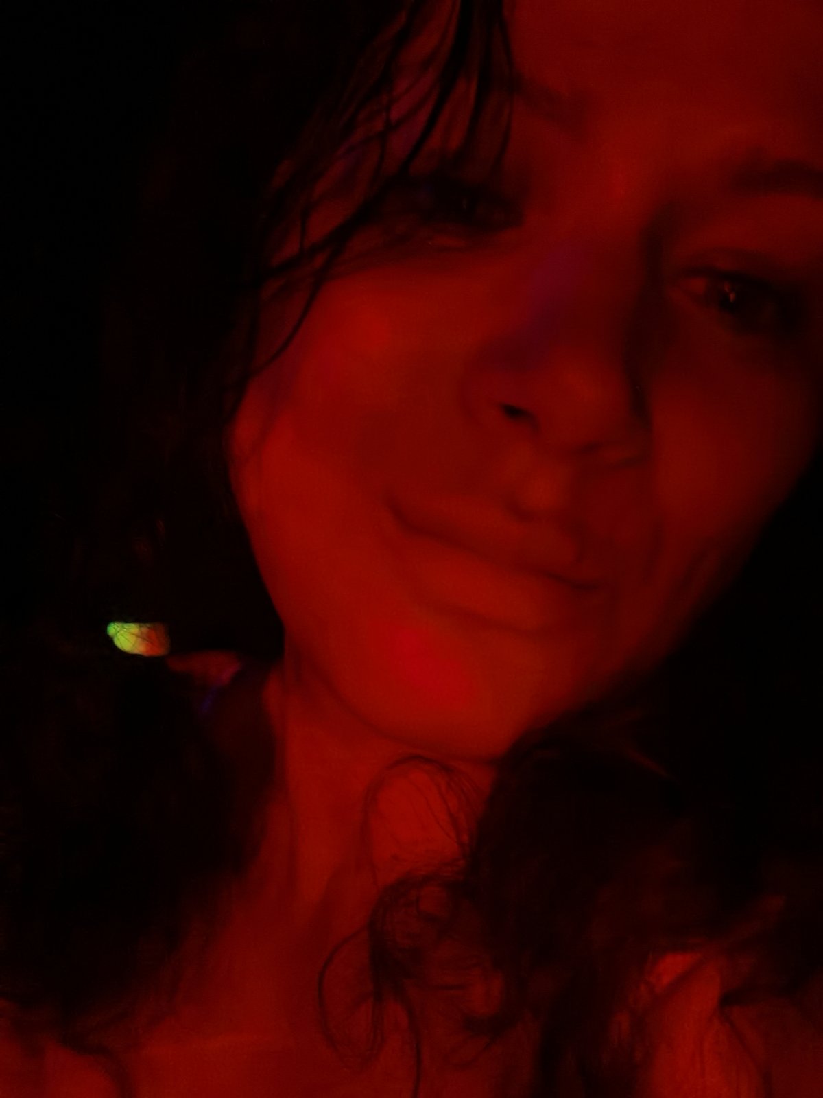 Colored light portrait session captured in dimly lit environment
