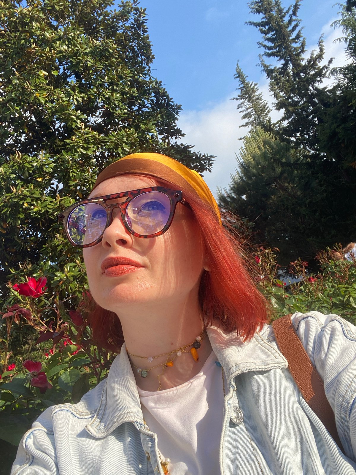 Tourist photographs red-haired woman sightseeing in Sochi attractions