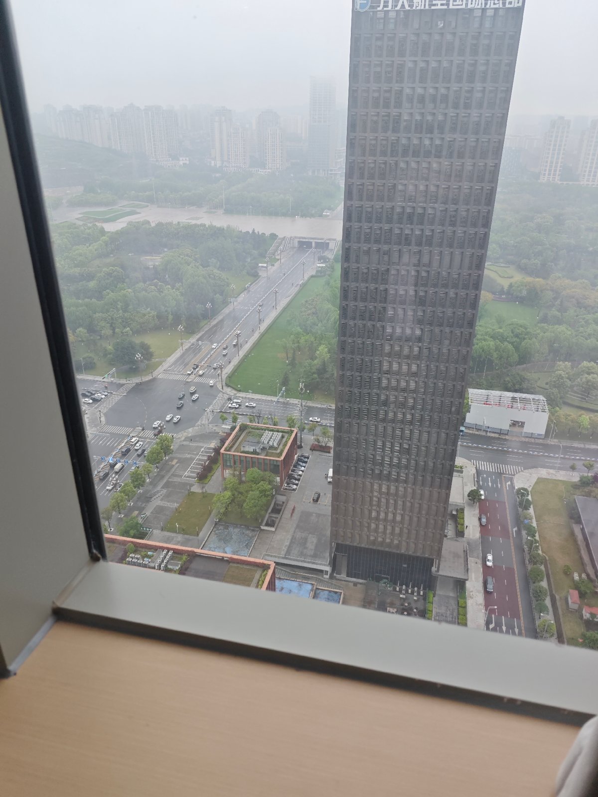 Heavy mist shrouds Liangjiang cityscape viewed from high-rise