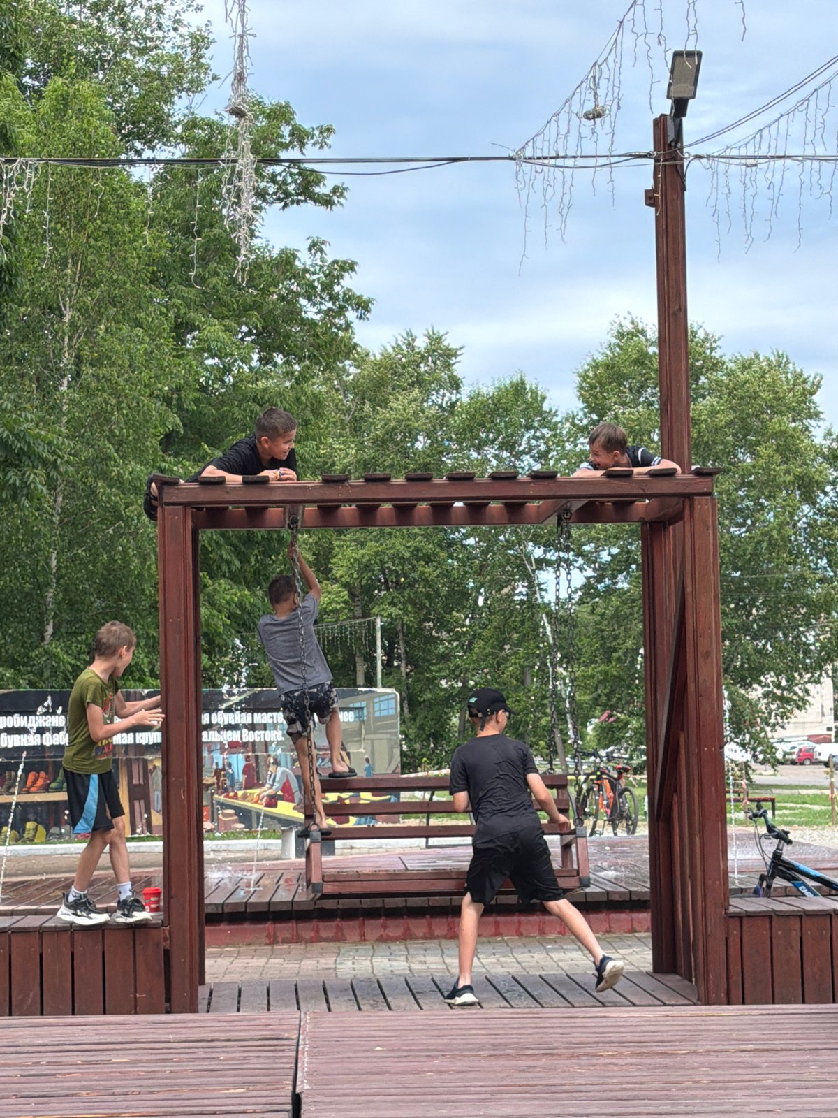 Kids at a splash pad and playground in Birobidzhan on a summer day