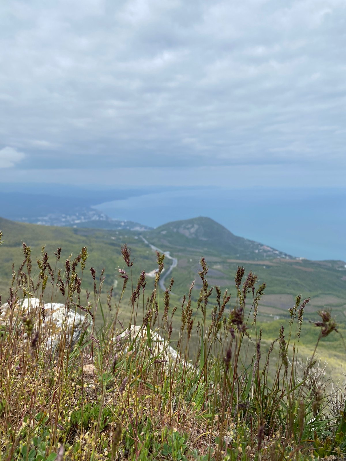 Witness captures overcast coastal mountain views from Ukrainian hillside