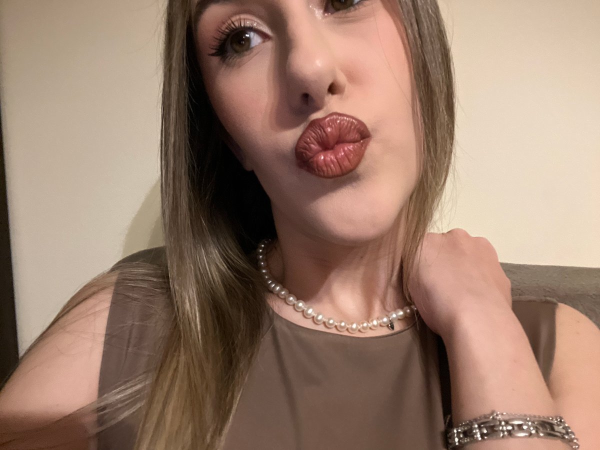 Woman takes selfie in Sofia wearing pearls and brown top