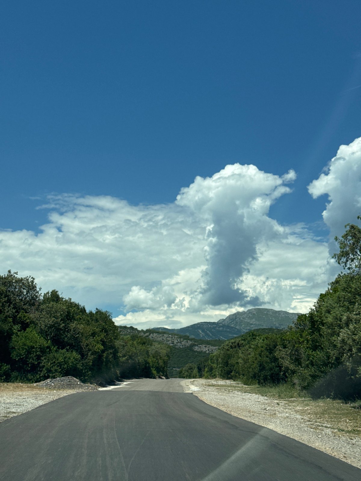 Mountain road and rocky shoreline in coastal Montenegro