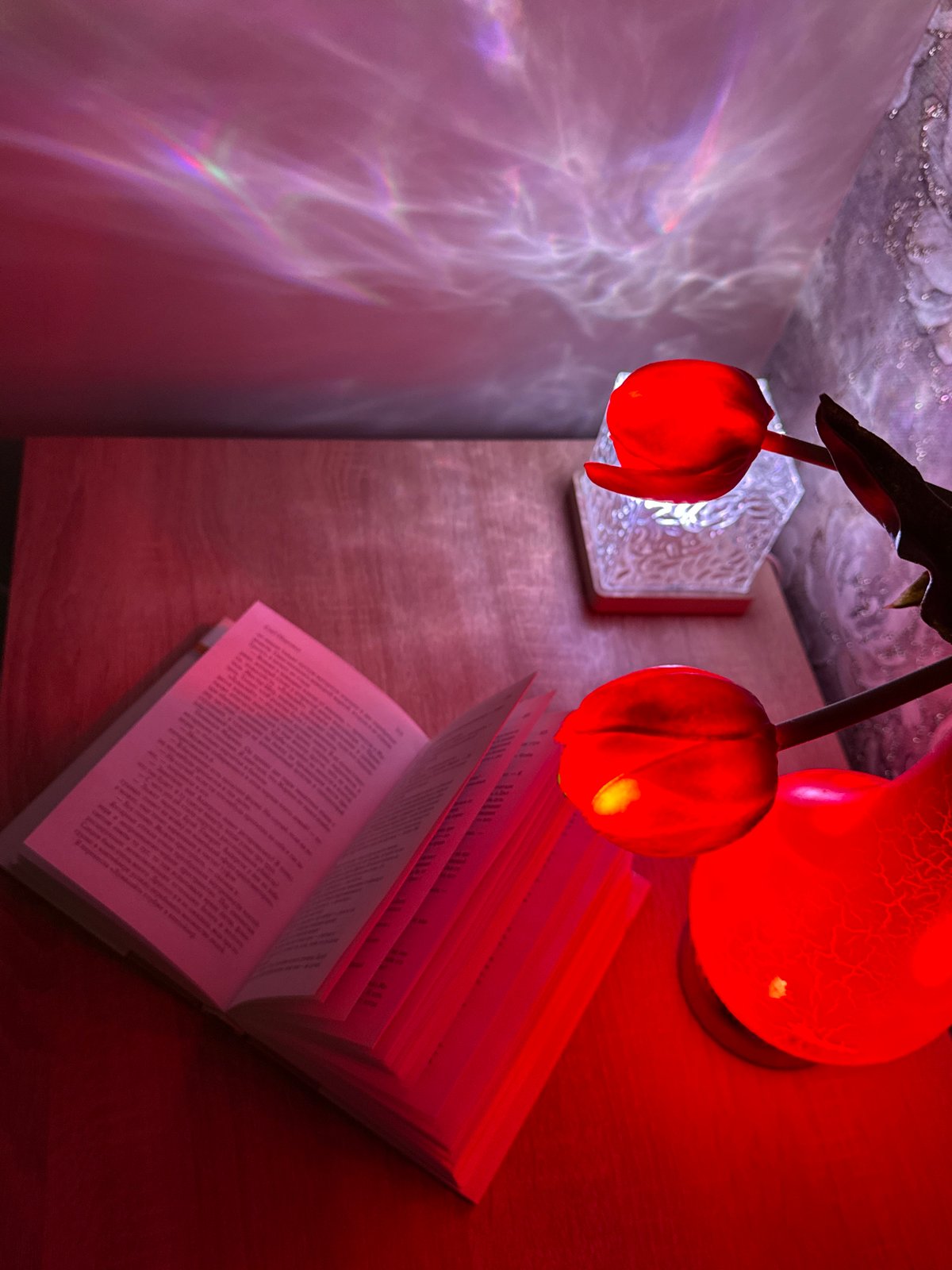 Open book with Cyrillic text photographed under red lighting