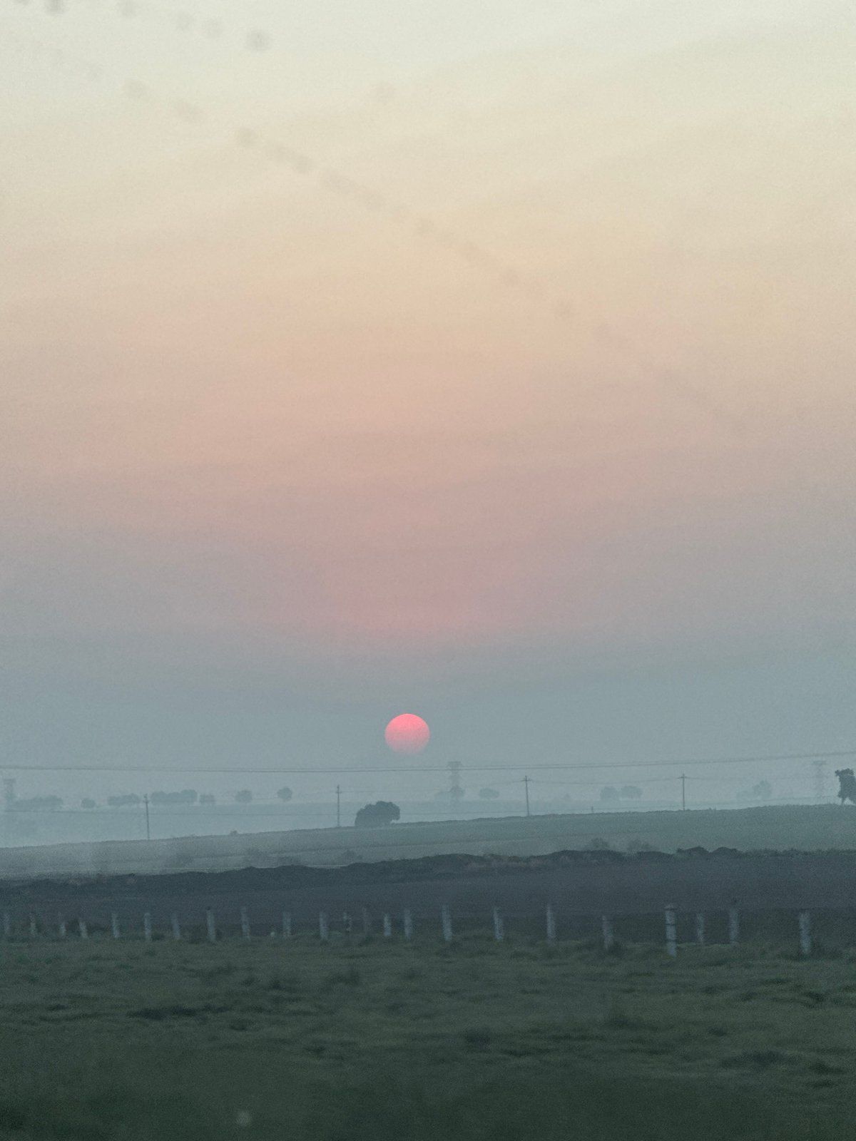 Red sun observed through hazy conditions in rural Mexico