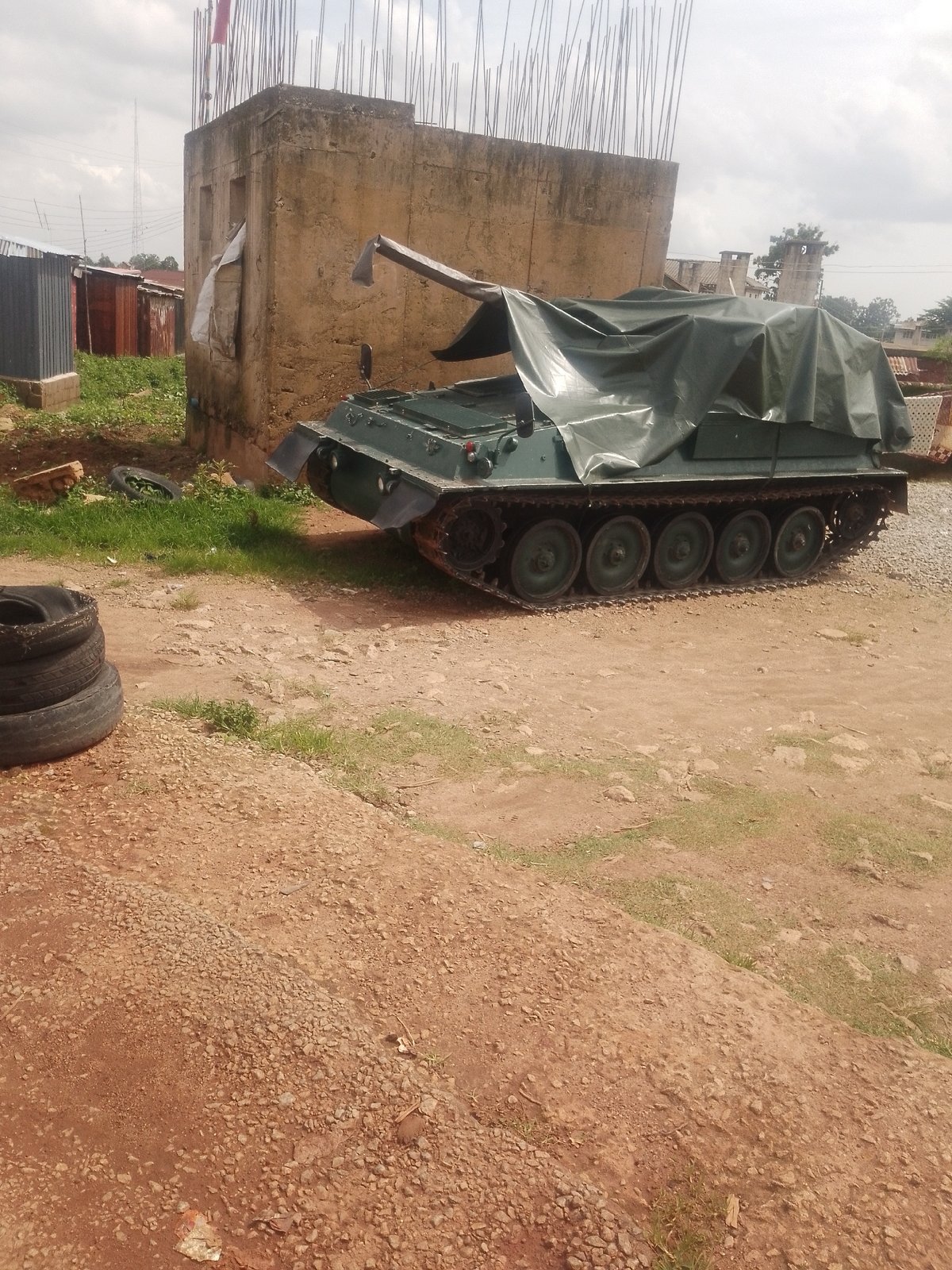 Street life and a covered military tank in Jos, Nigeria