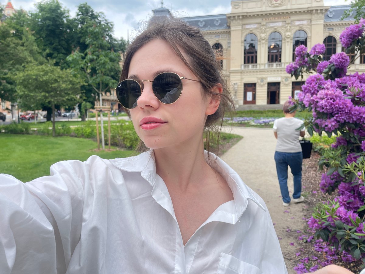 Tourist captures selfies amid blooming rhododendrons at Karlovy Vary spa