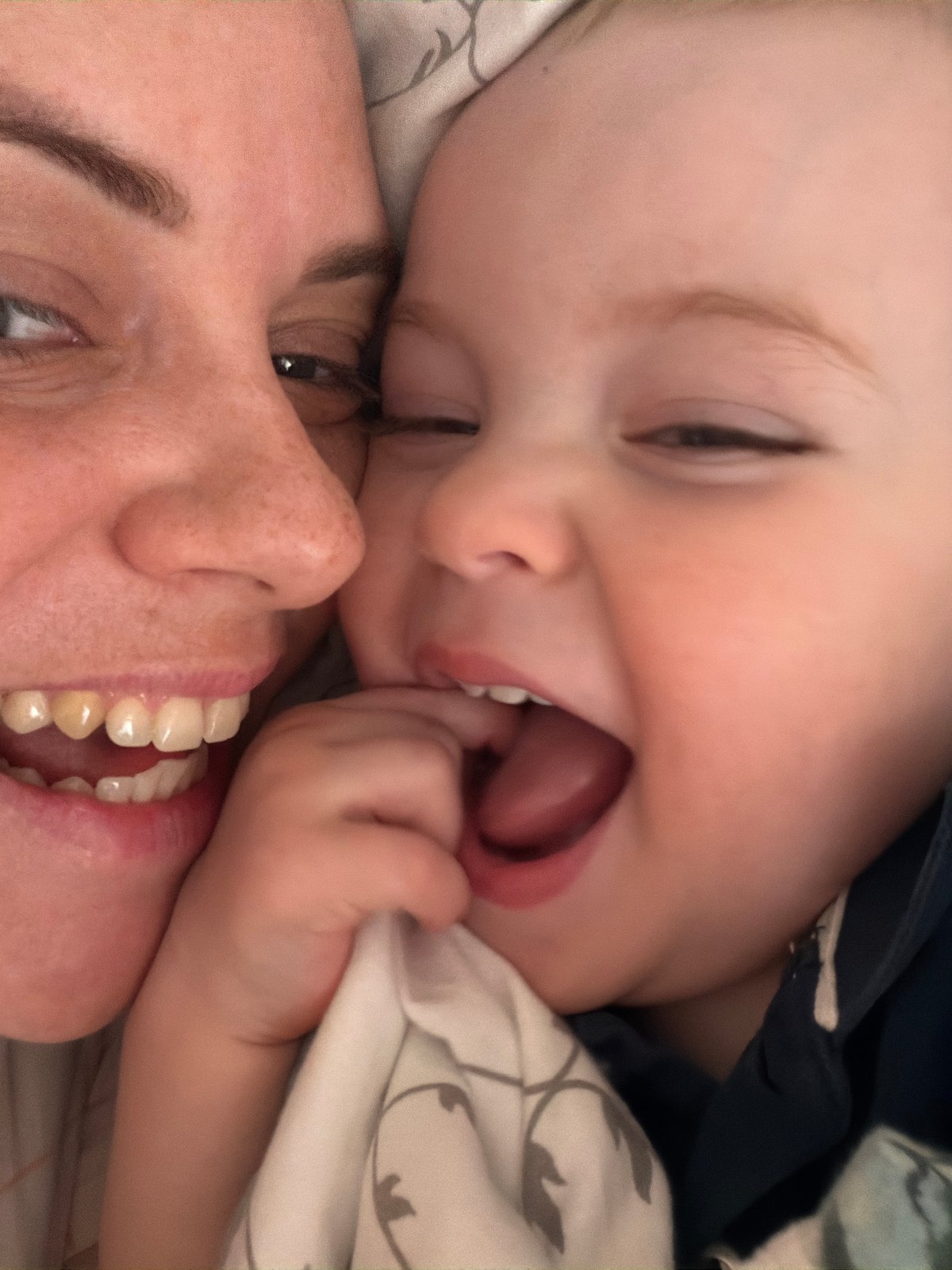 Baby plays with toys alongside chihuahua in Votkinsk bedroom
