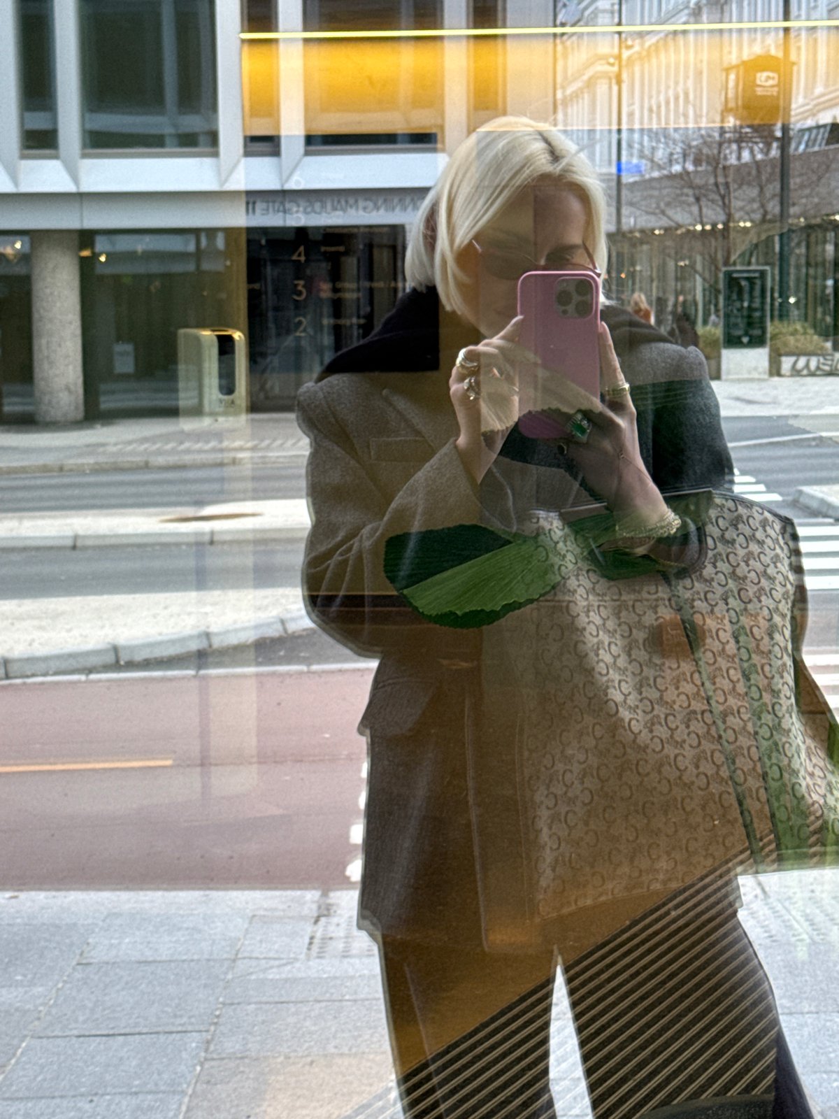 Blonde woman films fashion content with Celine bag in Oslo