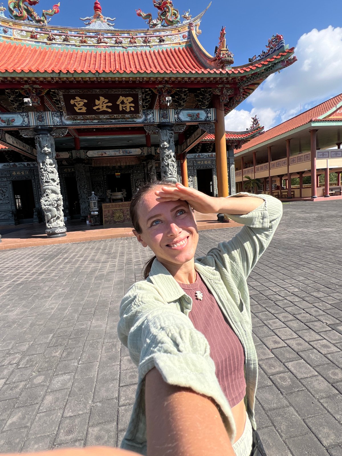 Tourist visits ornate Buddhist temple complex in Denpasar, Indonesia