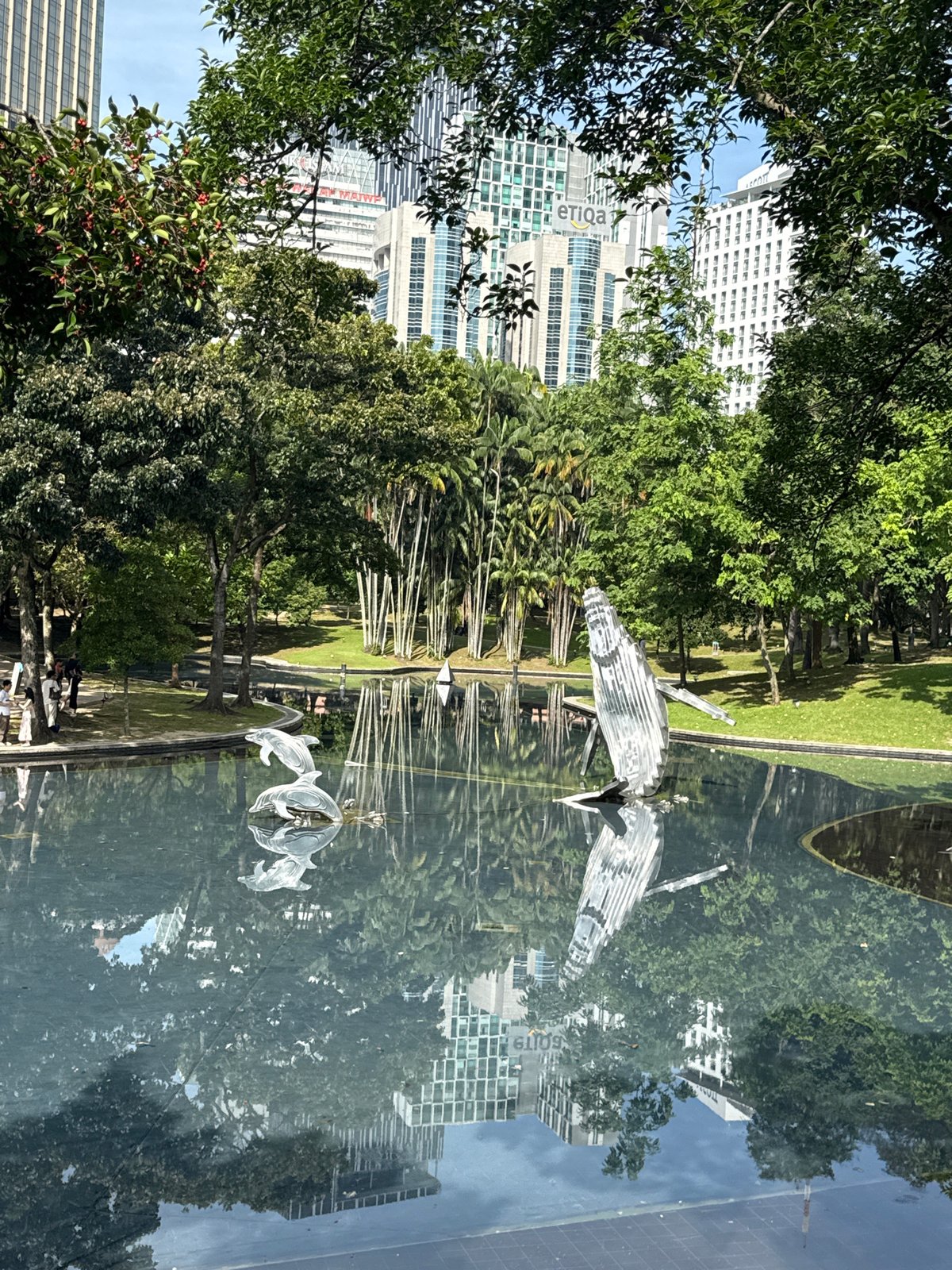 Late-night strollers enjoy Kuala Lumpur parks near Petronas Towers