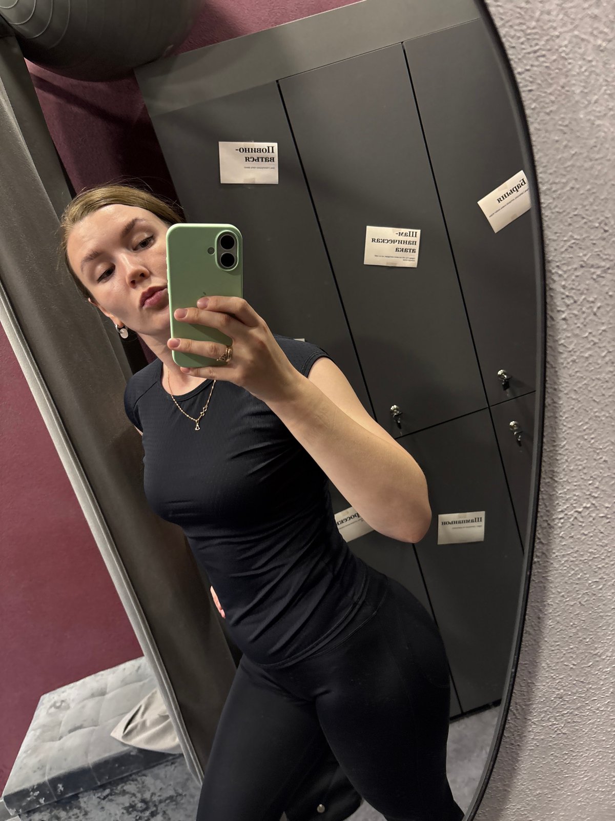 Woman takes mirror selfies with green phone in Izhevsk