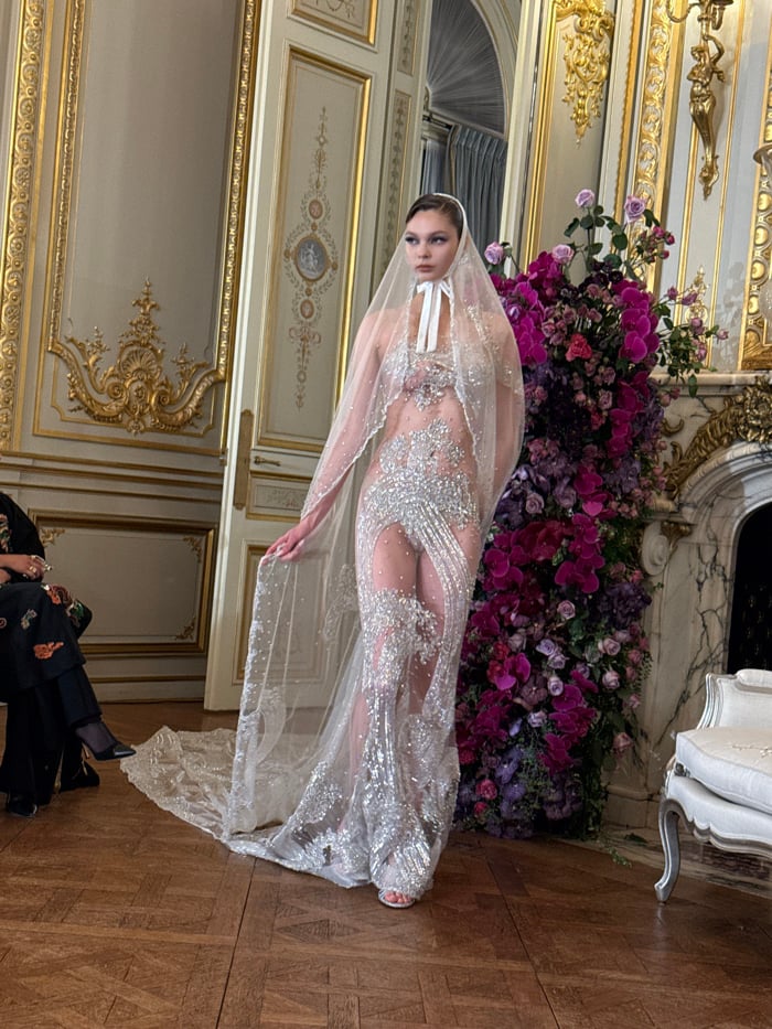 Fashion show presents evening wear collection in ornate Parisian venue