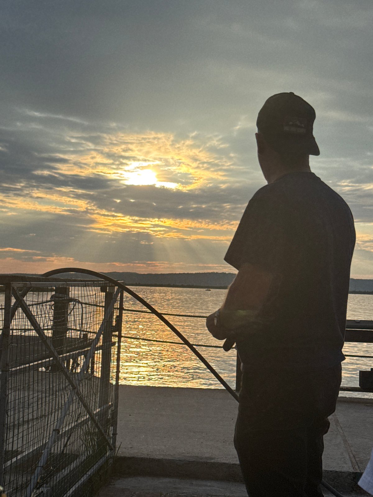 Sunset gathering documented along Kama River waterfront in Chaikovsky