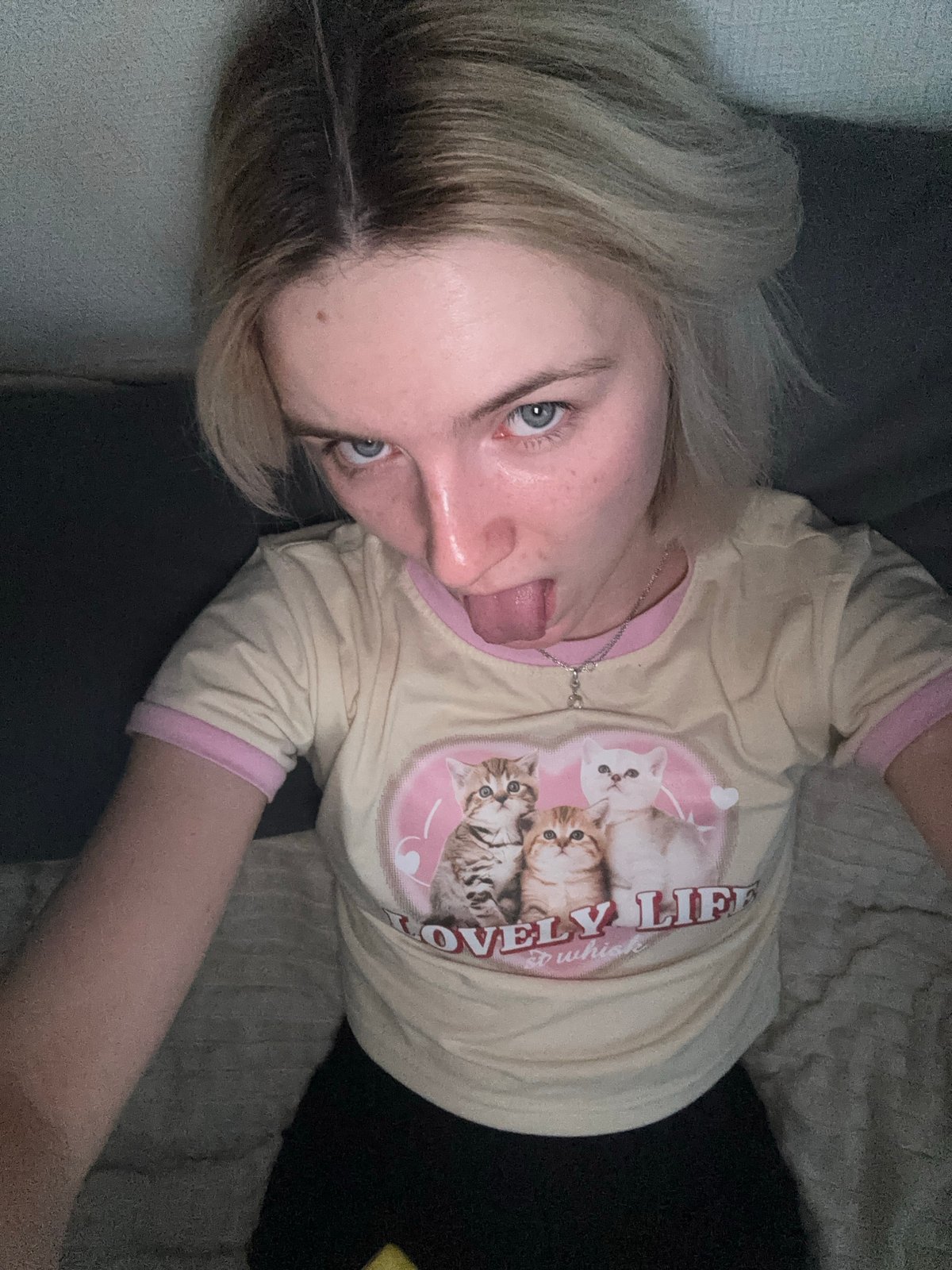 Person in cat-print shirt resting indoors in Russia