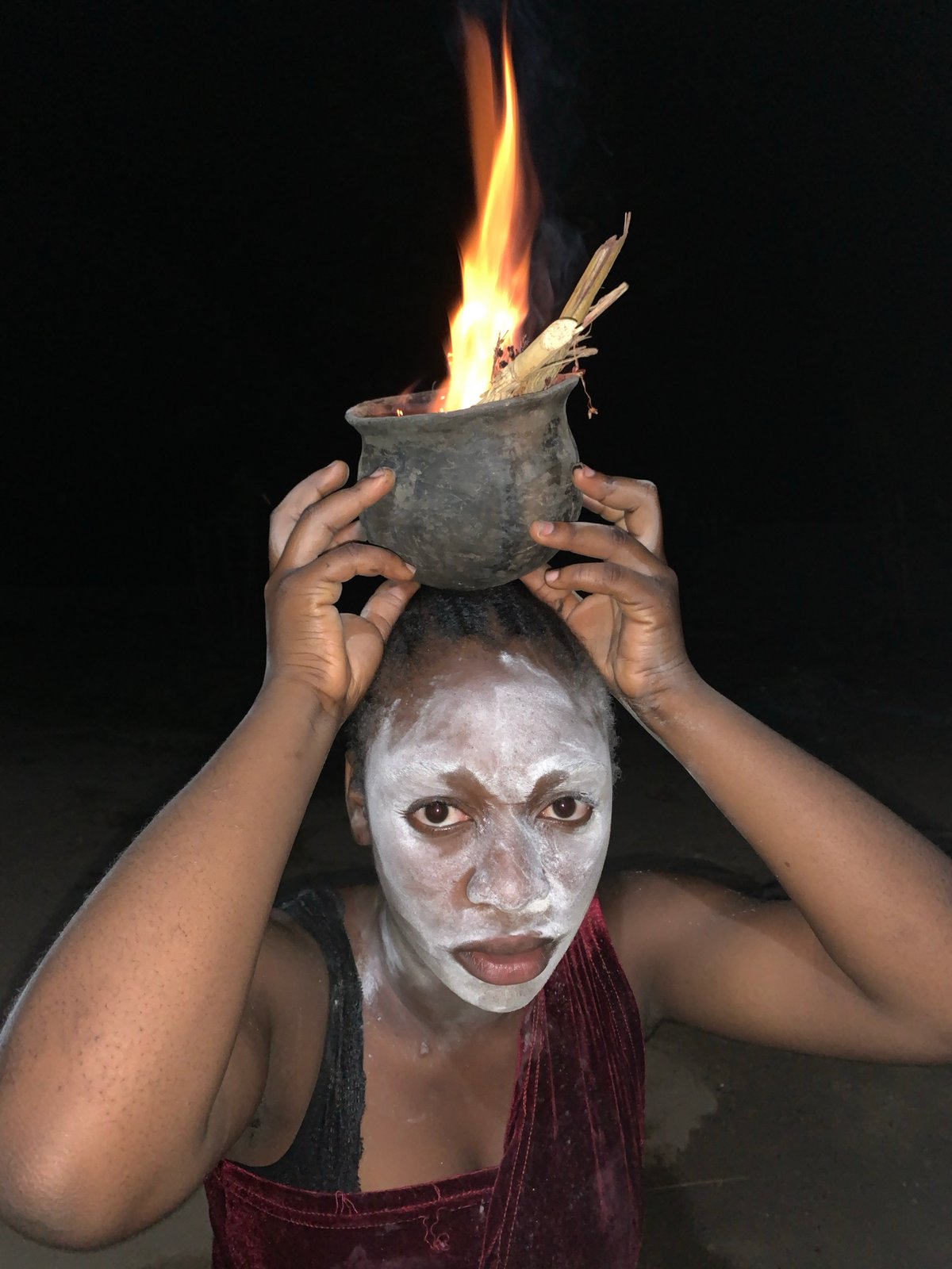 Person holds fire pot in traditional ceremony, Kukum Nigeria