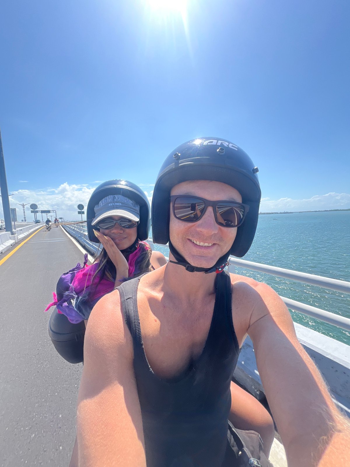 Motorcycle crossing a scenic bridge in Kuta Selatan, Bali