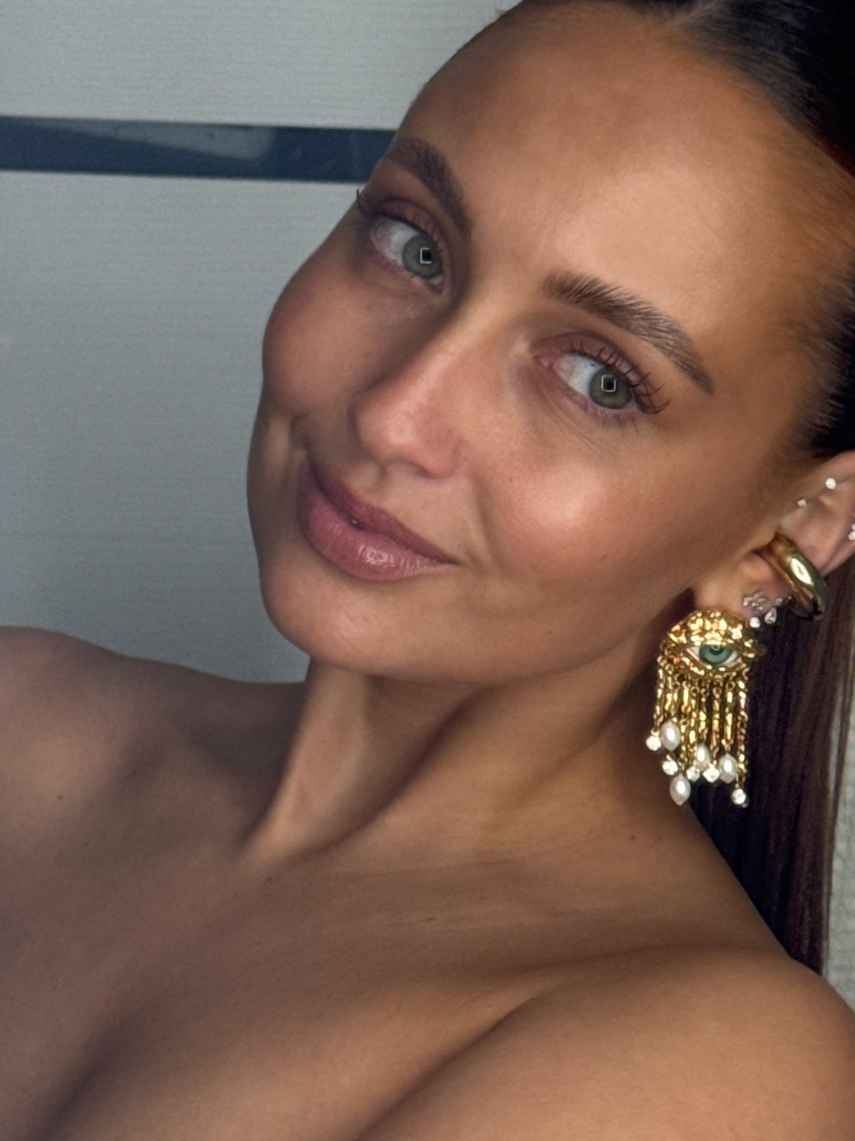 Woman photographed wearing gold ear jewelry in Chaikovsky, Russia