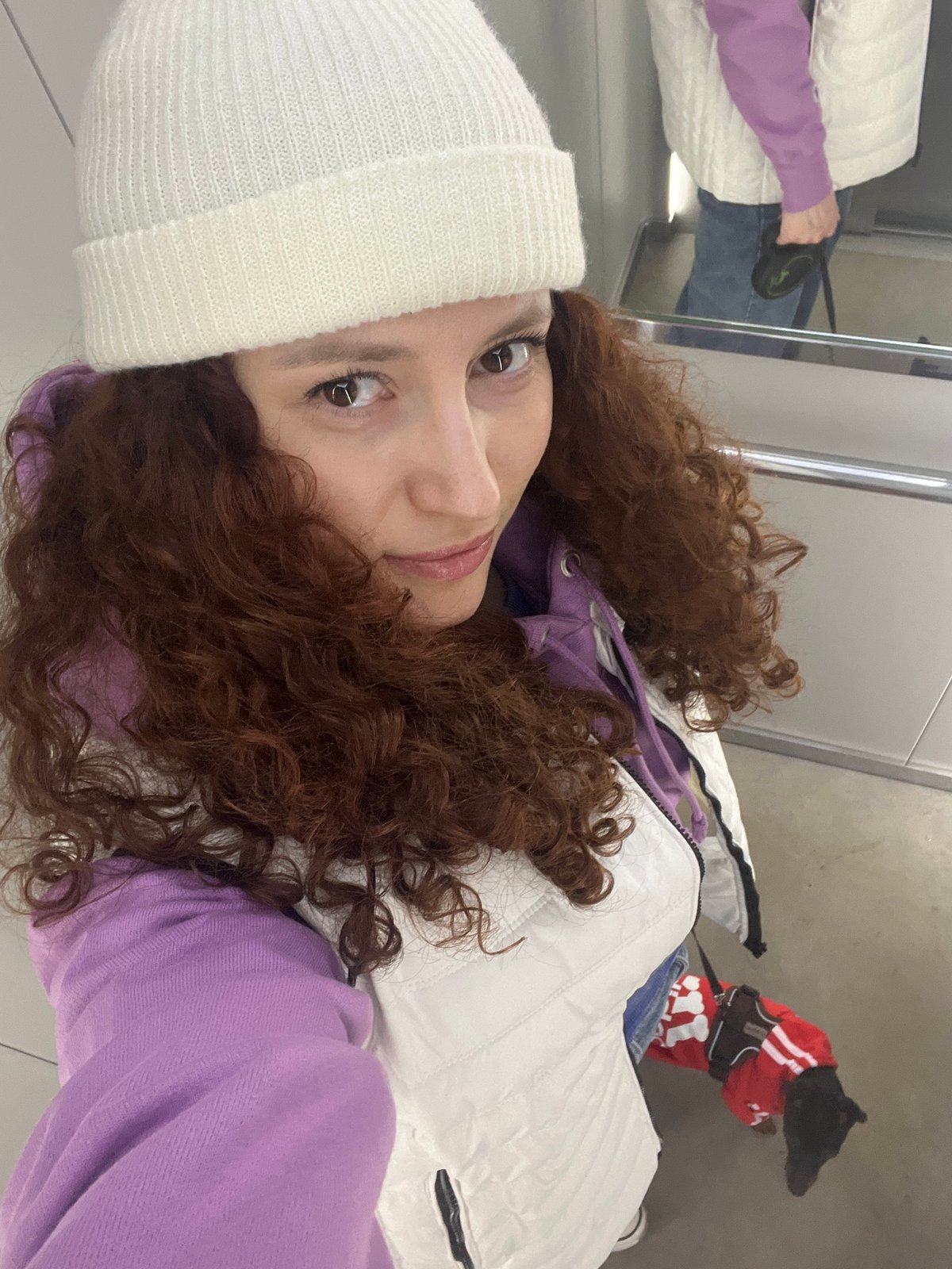 Woman and dressed-up dog spend casual afternoon in Saint Petersburg