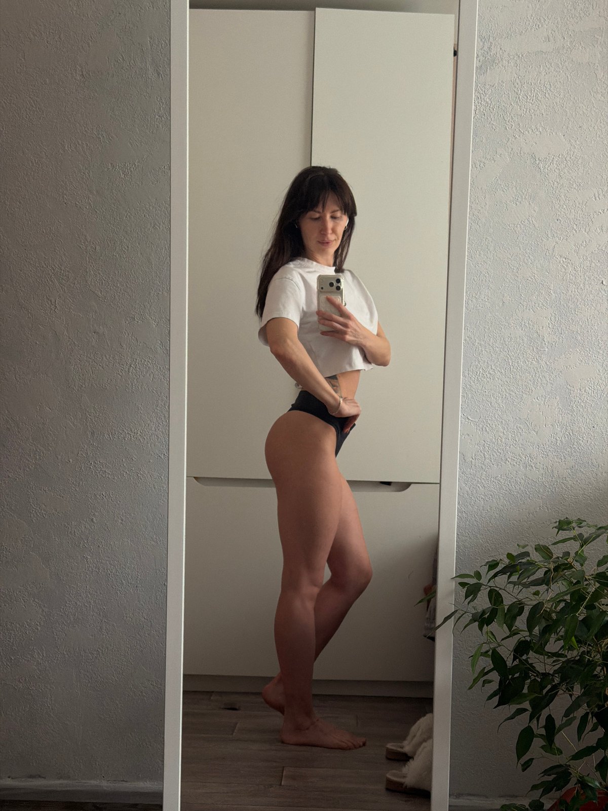 Woman takes mirror selfies in Perm, Russia indoor location