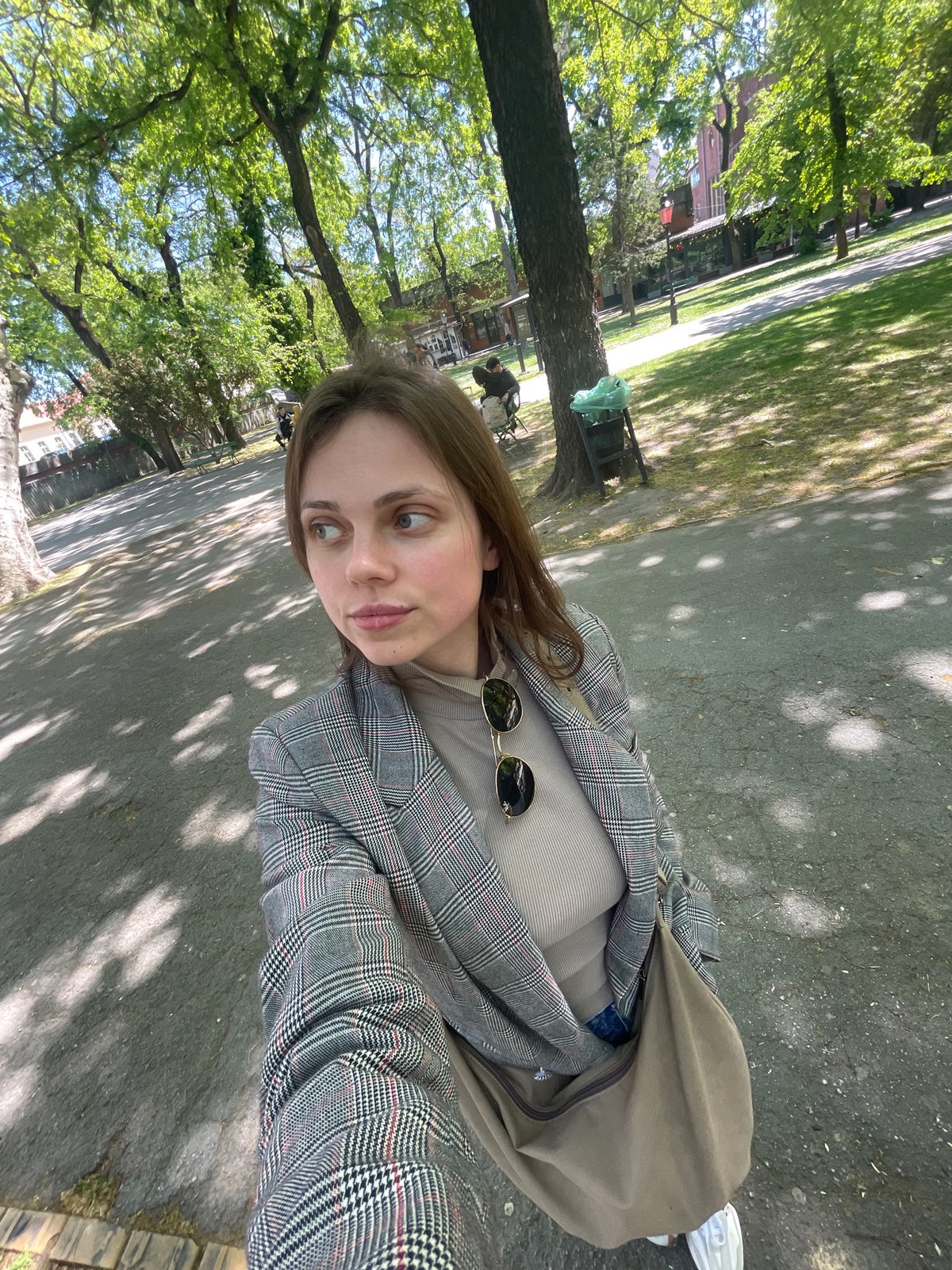 Woman photographs herself in Subotica park during morning outing