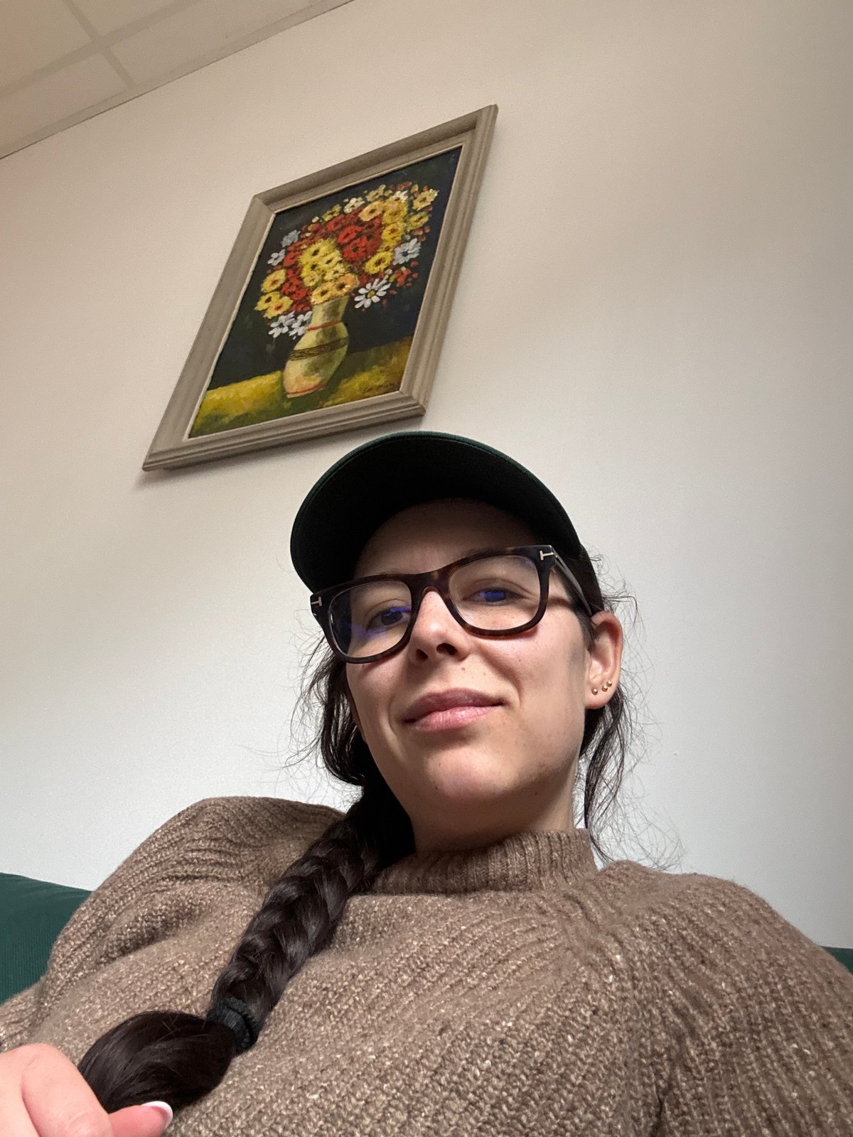Woman photographed indoors in Sofia with floral artwork backdrop