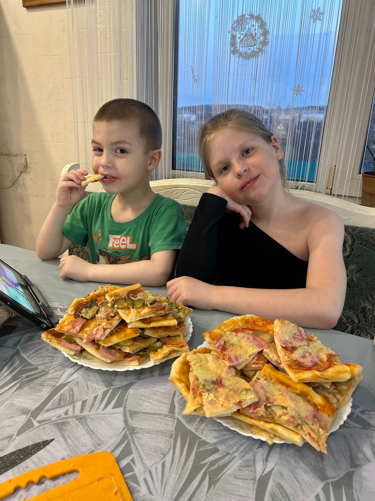 Family makes homemade pizza together in Russian village