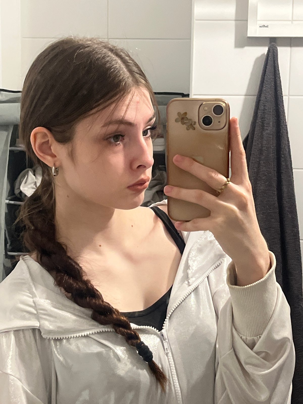 Young person takes mirror selfies in bathroom early morning