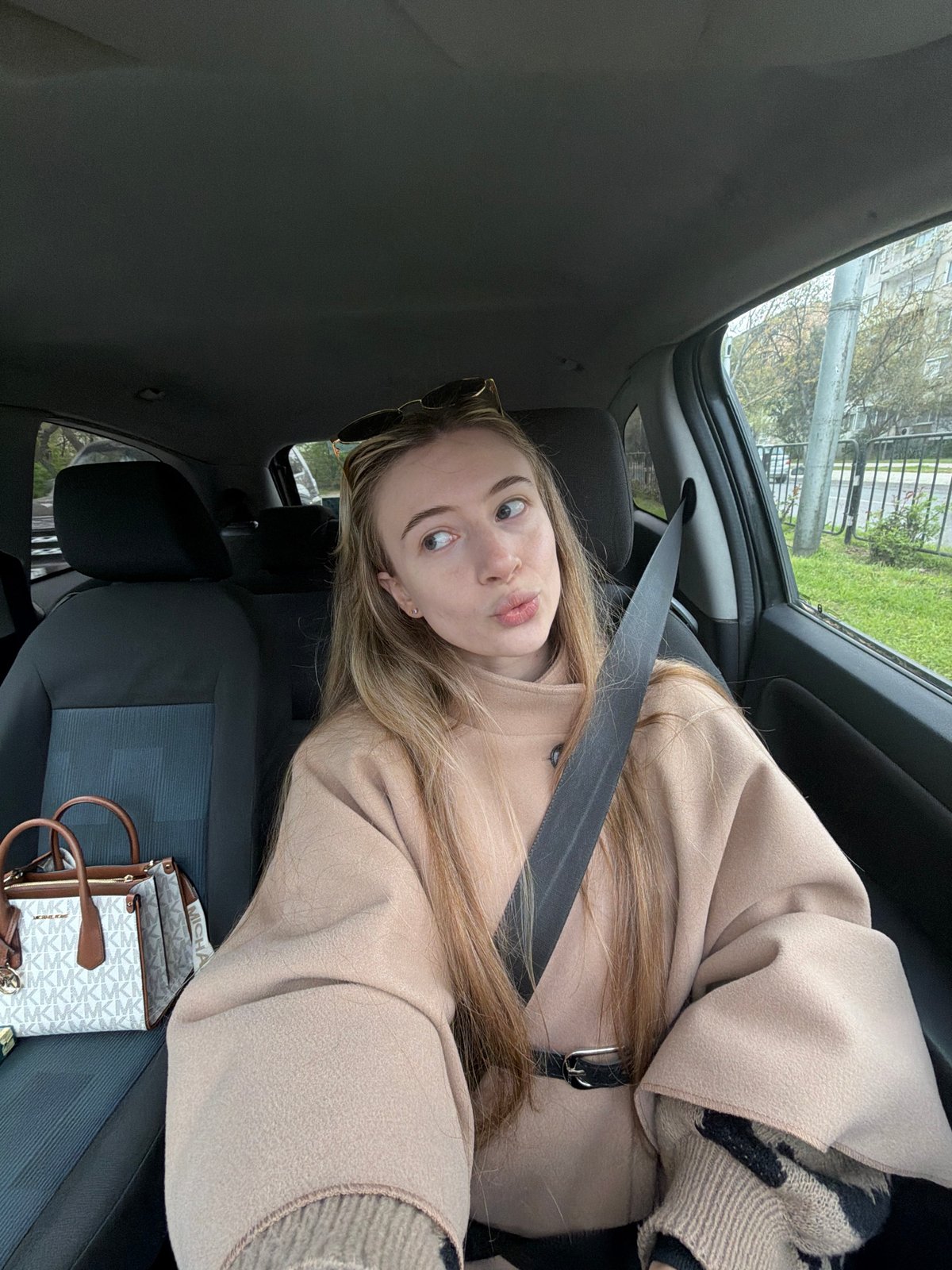 Woman in beige coat photographed in car, Plovdiv