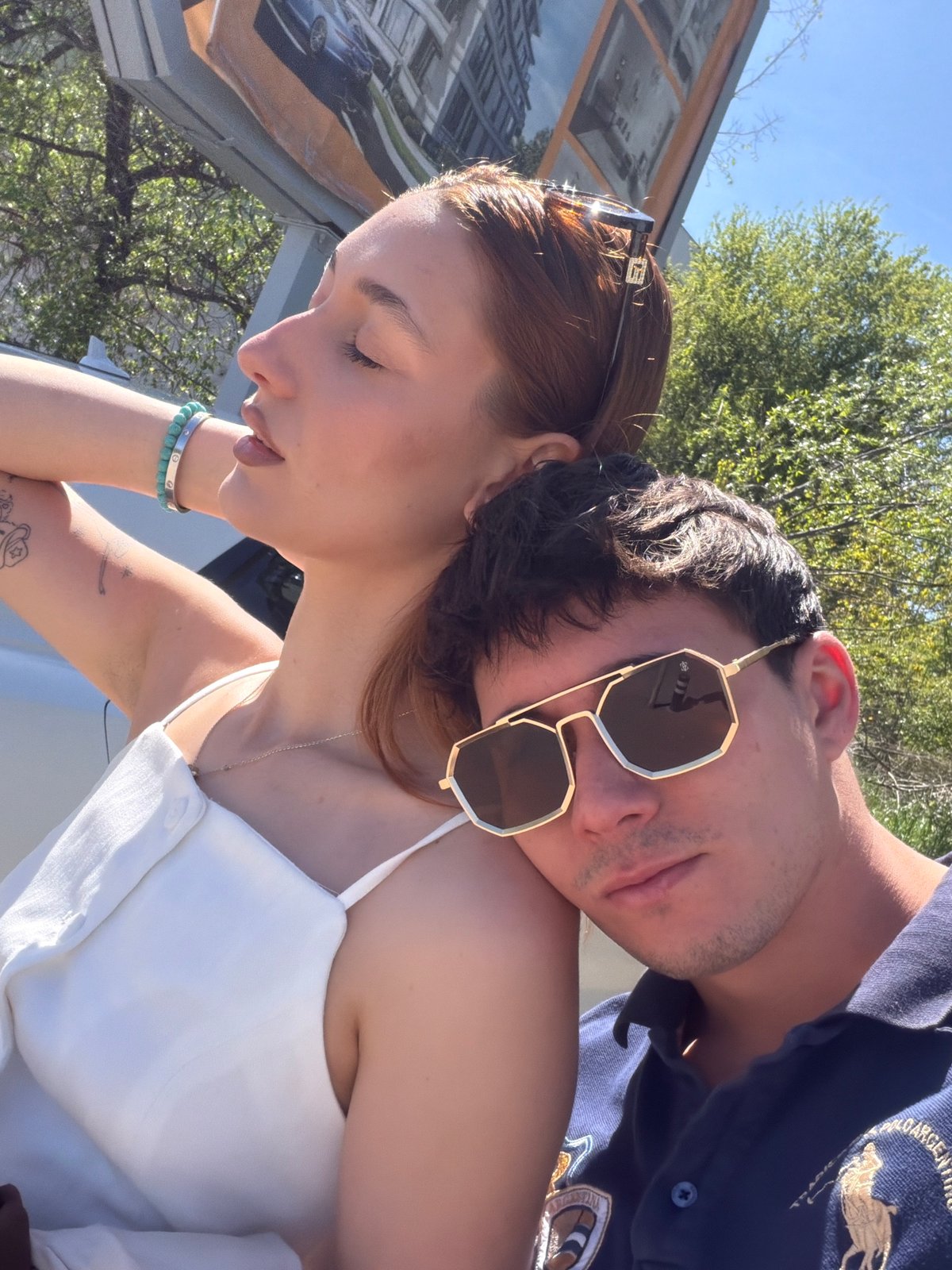 Couple takes selfies on Sofia sidewalk during midday outing